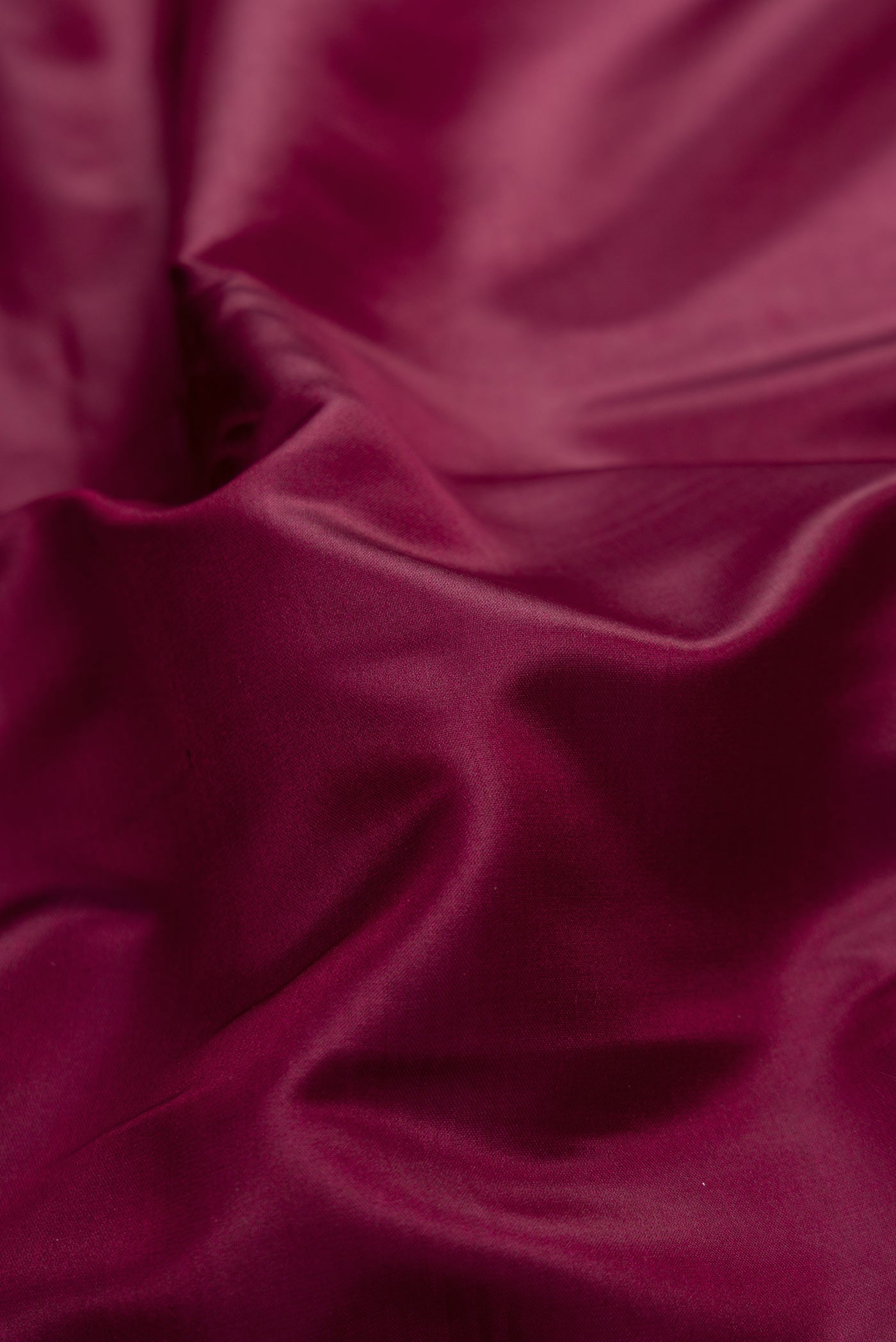 Close up of Burgundy Dual Tone Blended Banarasi Silk Saree with Plain Body and Fancy Border.  displaying folds