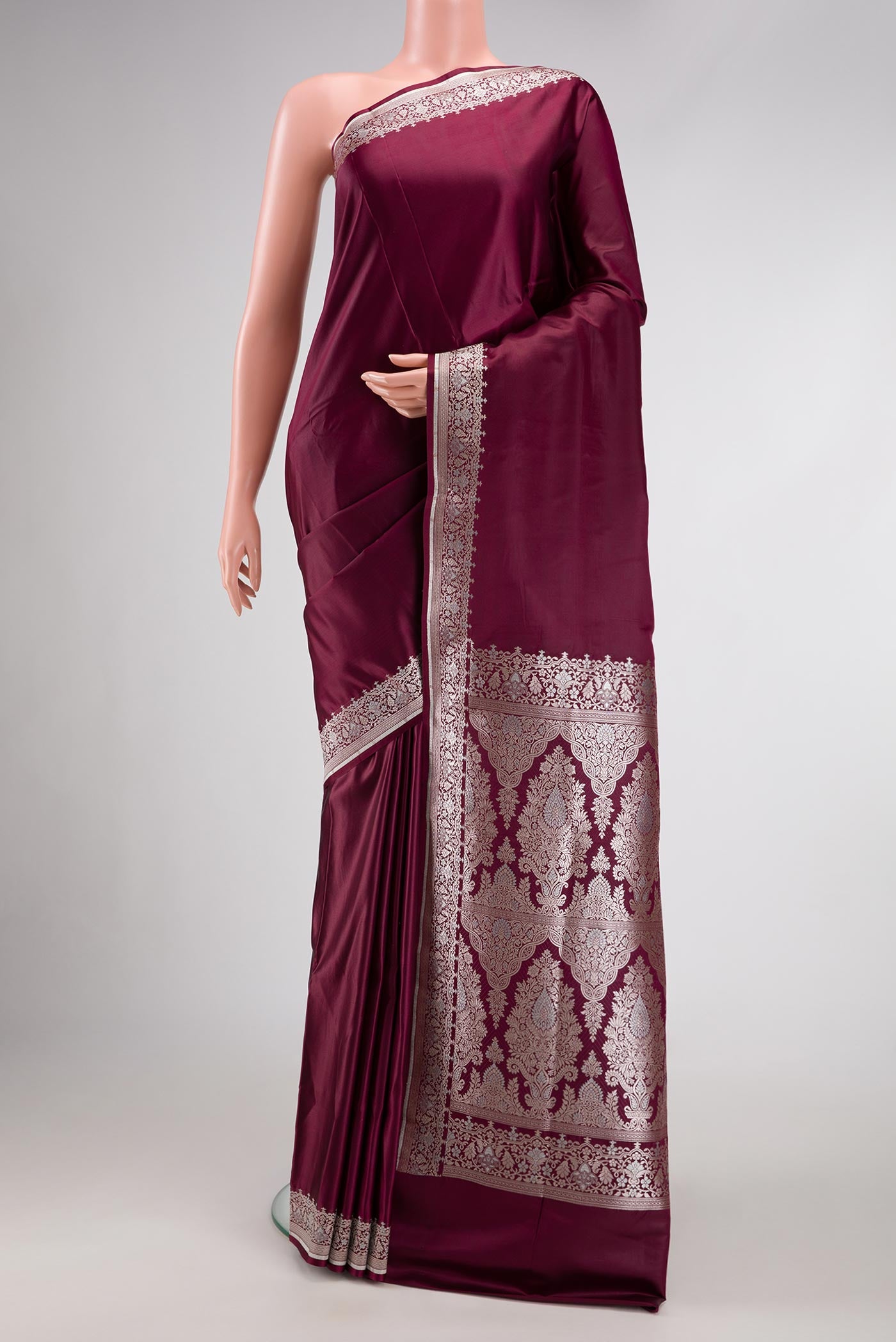 Burgundy Dual Tone Blended Banarasi Silk Saree with Plain Body and Fancy Border.  displayed on a mannequin