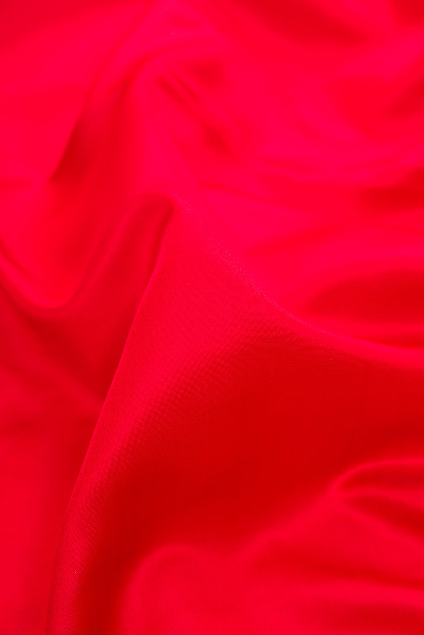 Close up of Red Dual Tone Banarasi Silk Saree with Plain Body and Fancy Border.  displaying folds