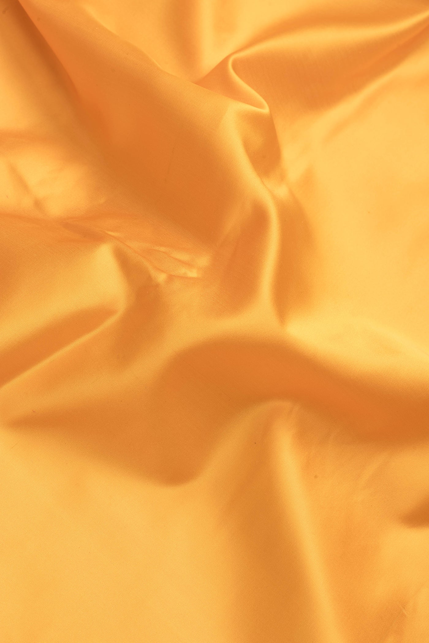 Close up of Yellow Dual Tone Blended Banarasi Silk Saree with Plain Body and Fancy Border.  displaying folds