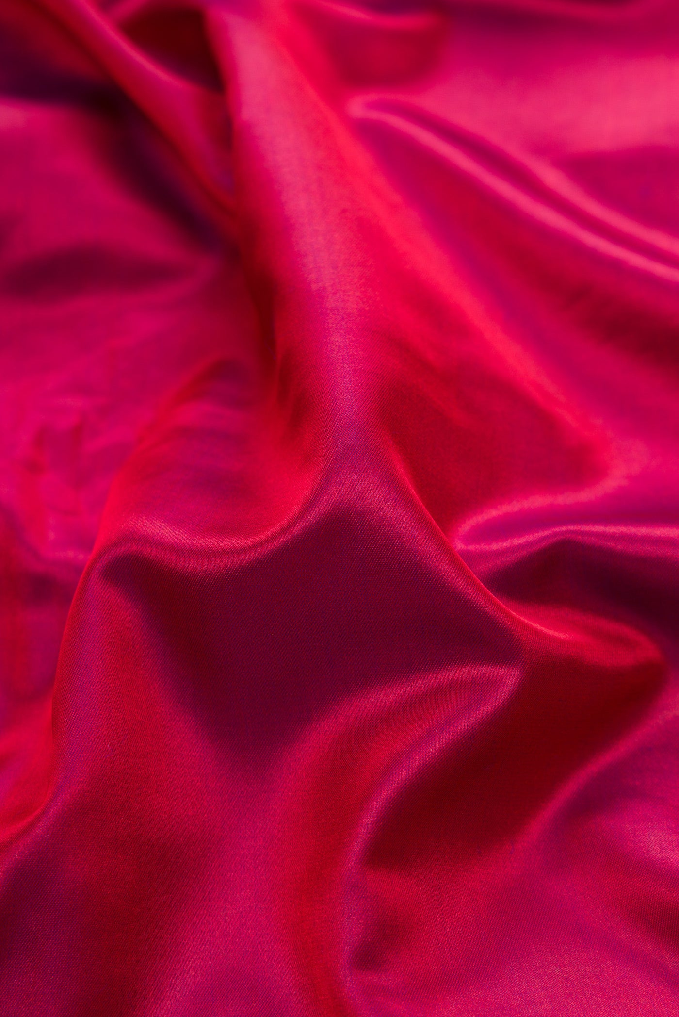 Close up of Maroon Dual Tone Banarasi Silk Saree with Plain Body and Fancy Border.  displaying folds