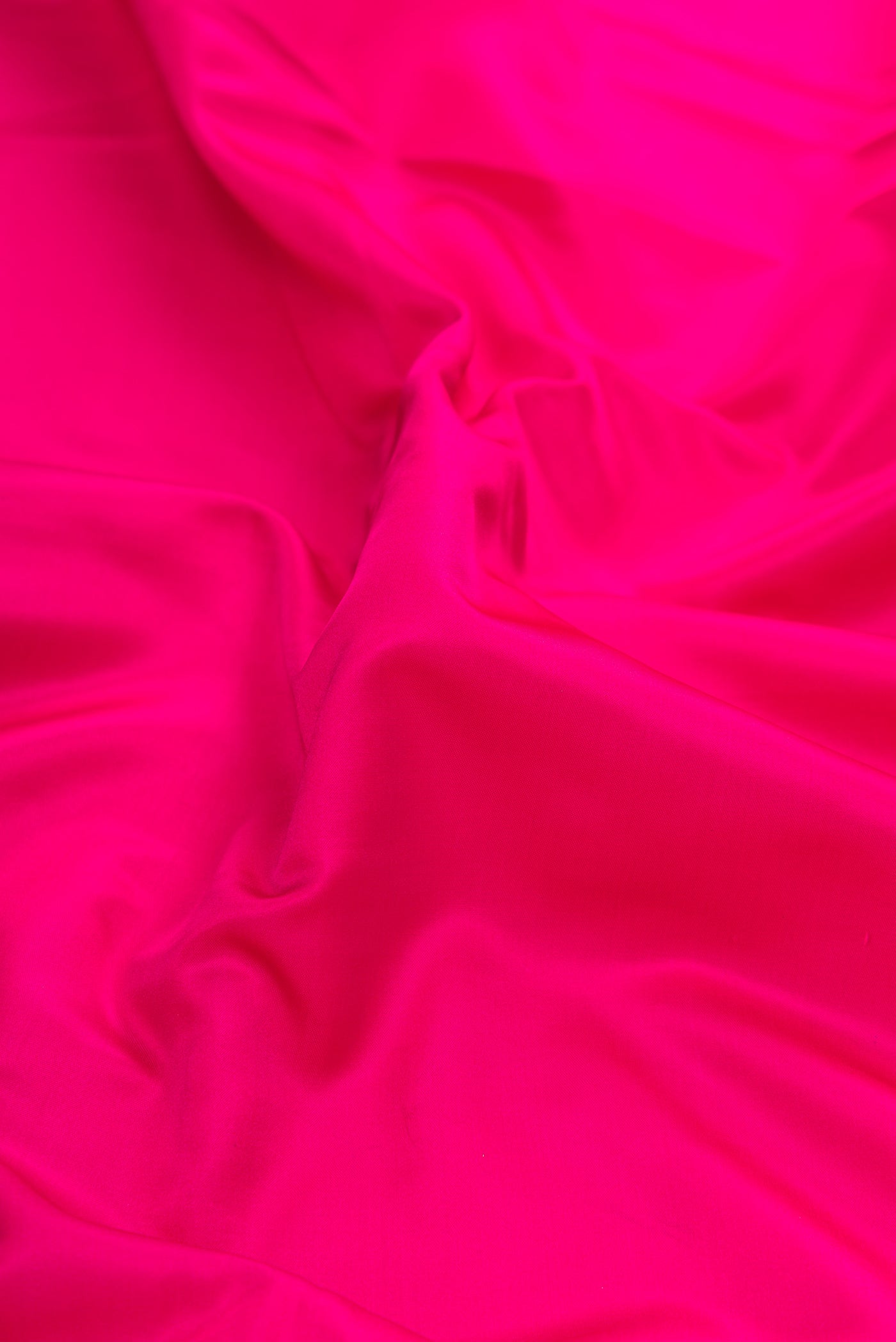 Close up of Pink Dual Tone Banarasi Silk Saree with Plain Body and Zari Border.  displaying folds
