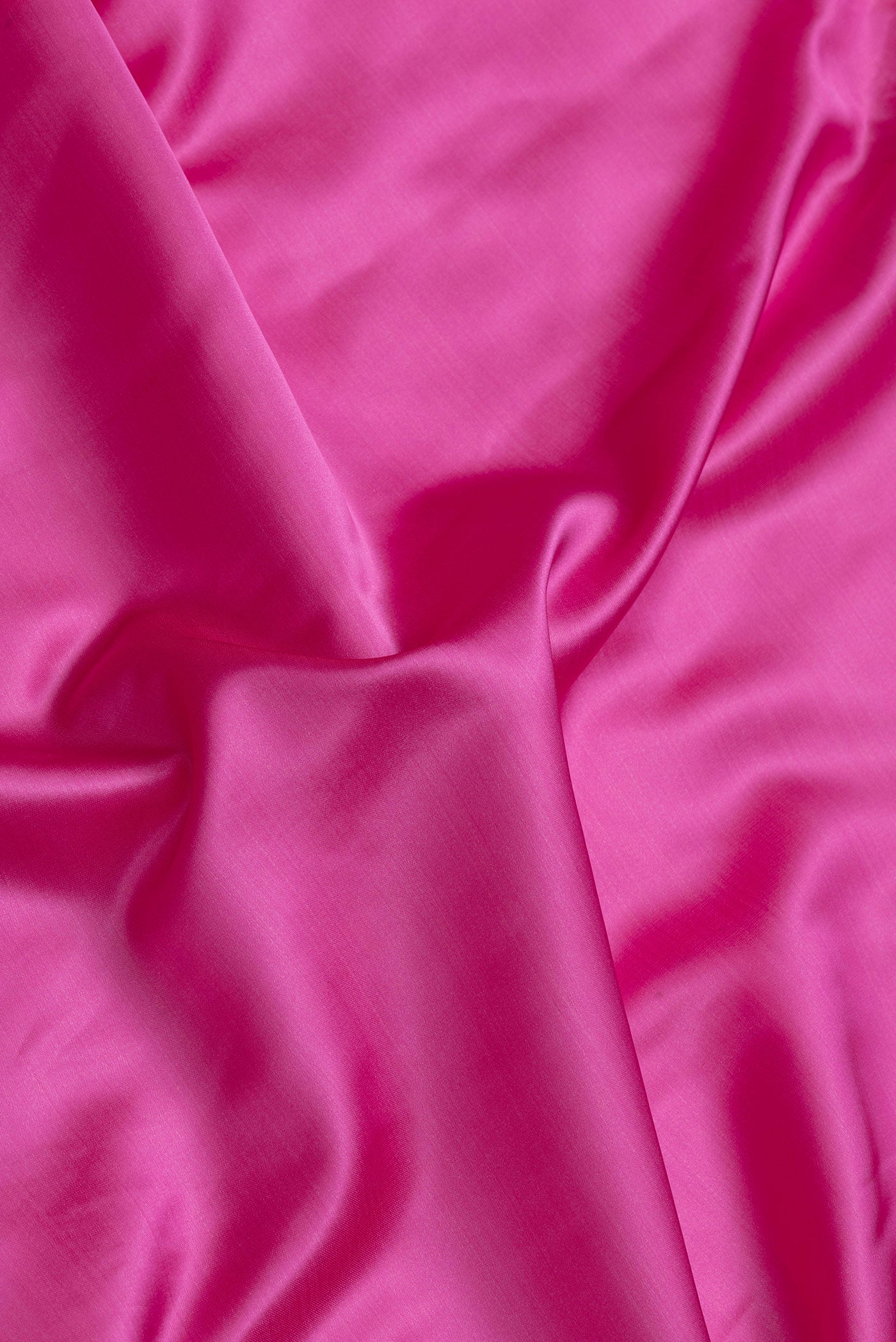 Close up of Pink Dual Tone Blended Banarasi Silk Saree with Plain Body and Fancy Border.  displaying folds