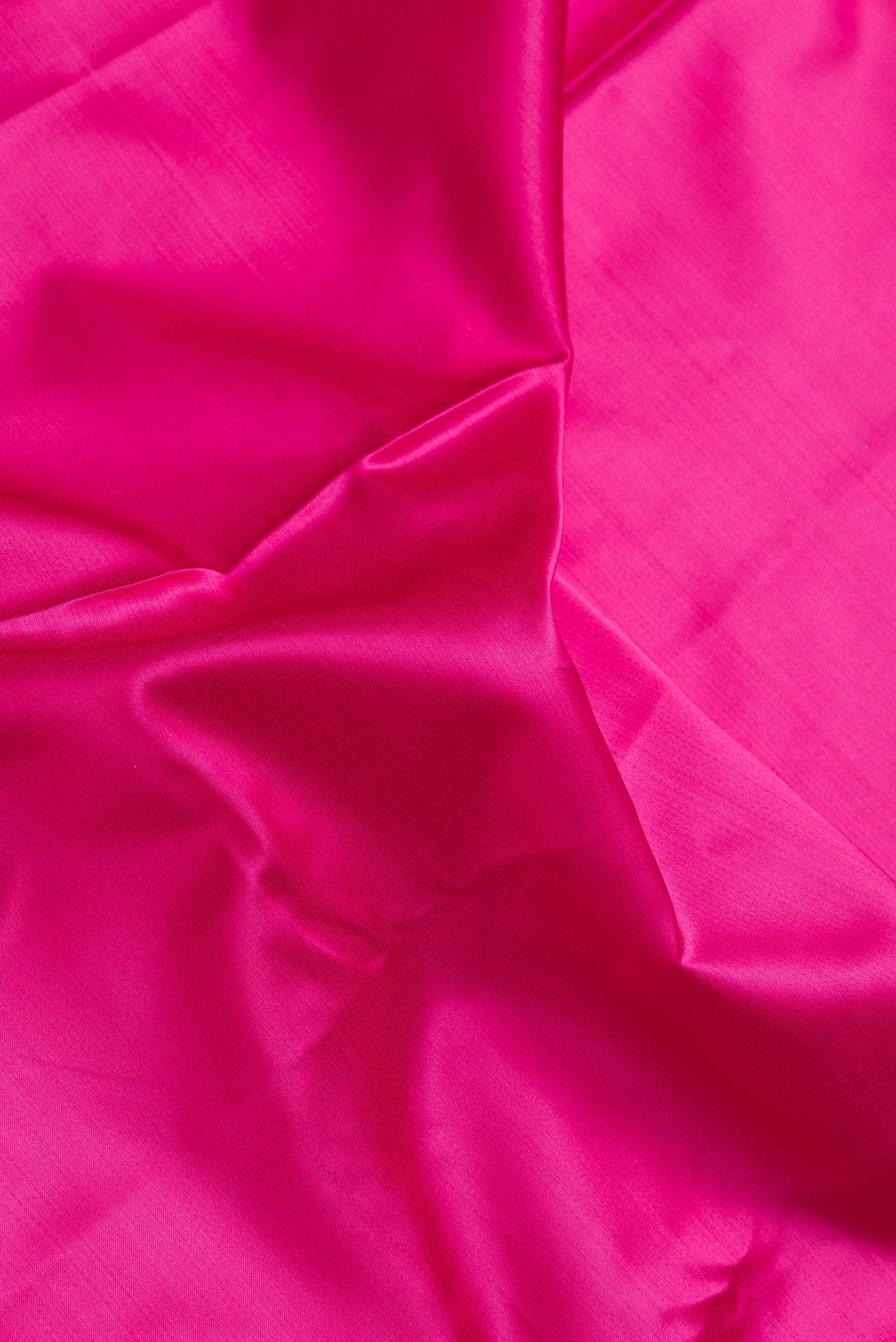 Close up of Pink Dual Tone Blended Banarasi Silk Saree with Plain Body and Fancy Border.  displaying folds