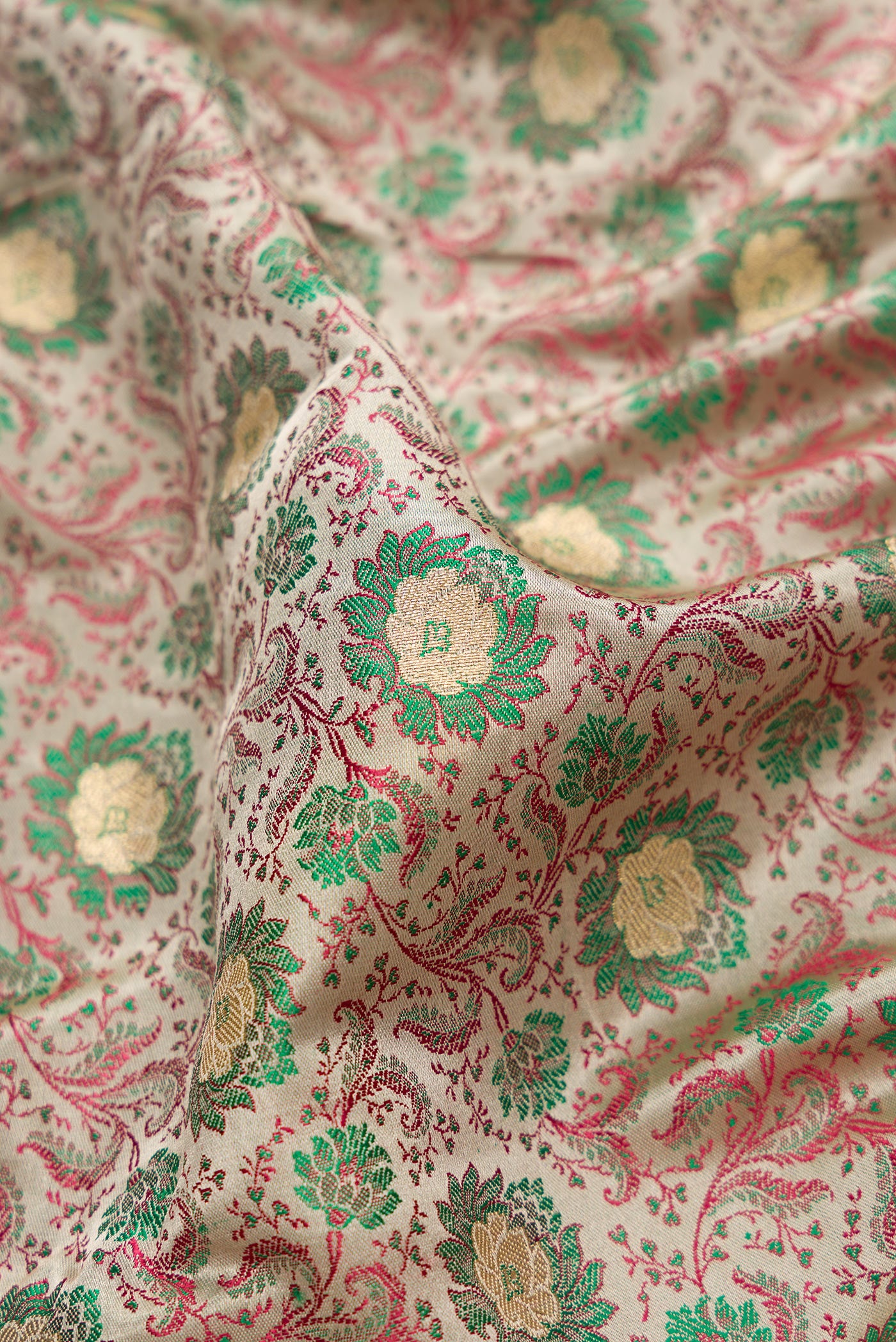 Close up of Grey Dual Tone Banarasi Silk Saree with Jacquard With Zari Butta on the body and Zari Border.  displaying folds