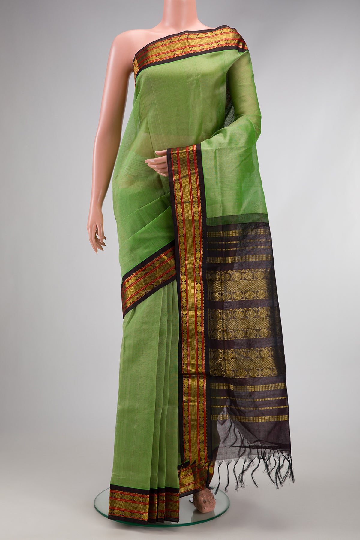 Light Green Silk Cotton Saree with Plain Body and Zari Border.  displayed on a mannequin