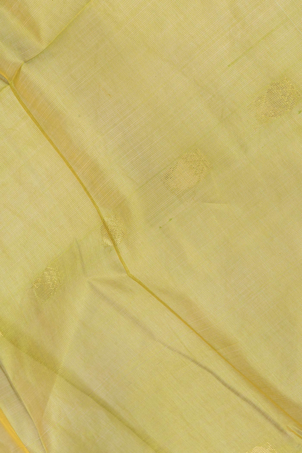 Close up of Green Dual Tone Silk Cotton Saree with Zari Butta on the body and Zari Border.  displaying folds