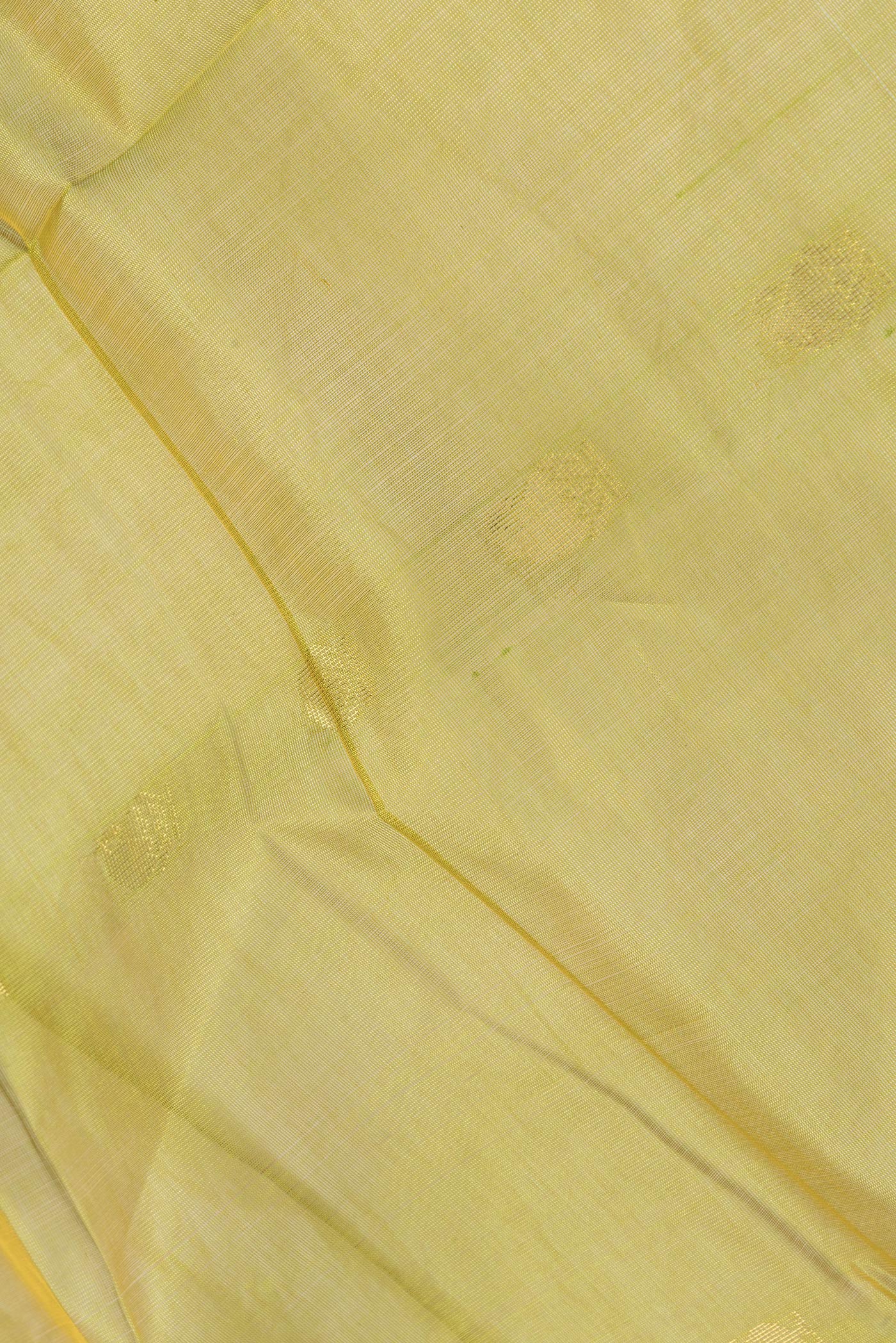 Close up of Green Dual Tone Silk Cotton Saree with Zari Butta on the body and Zari Border.  displaying folds