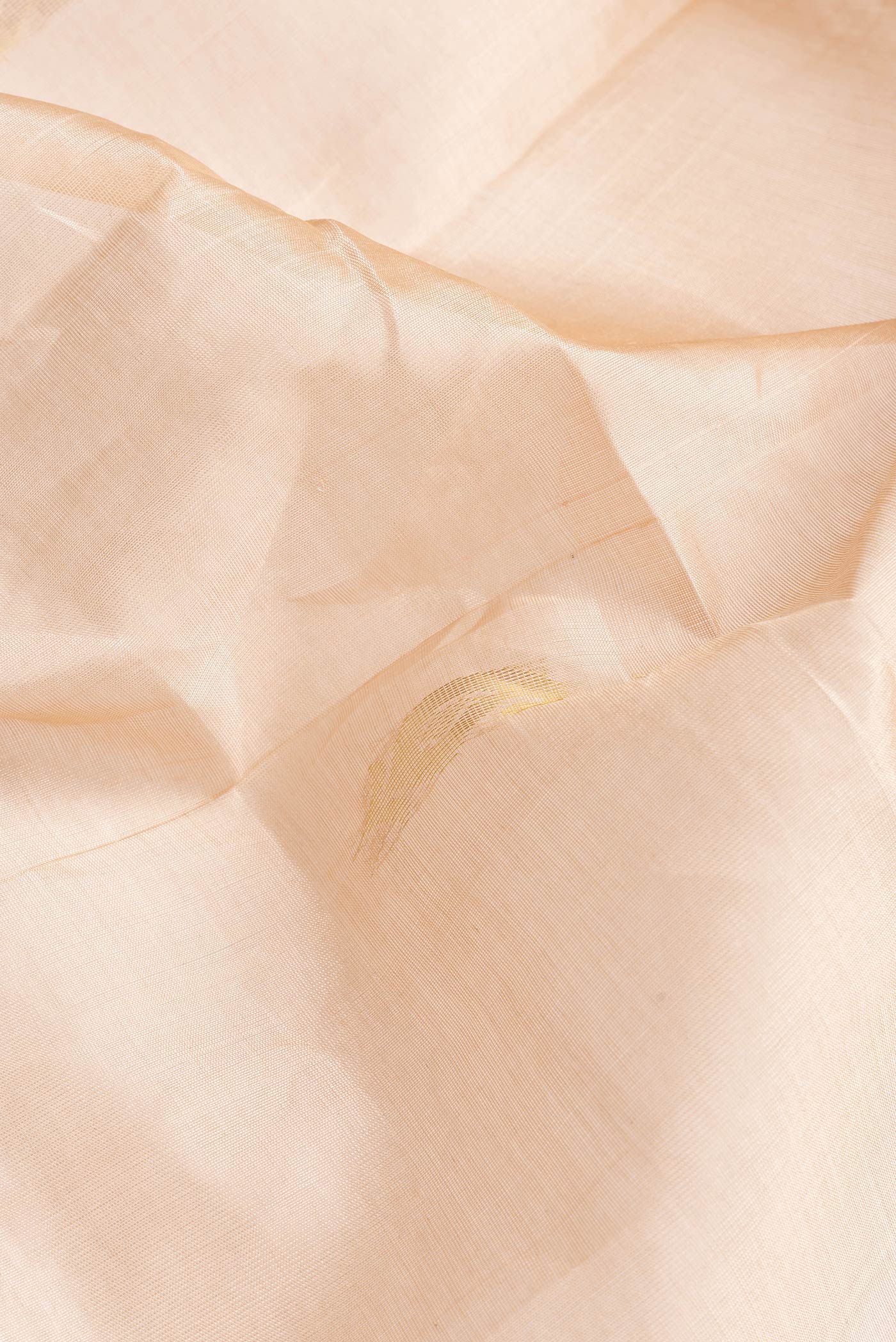 Close up of Caramel Dual Tone Silk Cotton Saree with Zari Butta on the body and Zari Border.  displaying folds