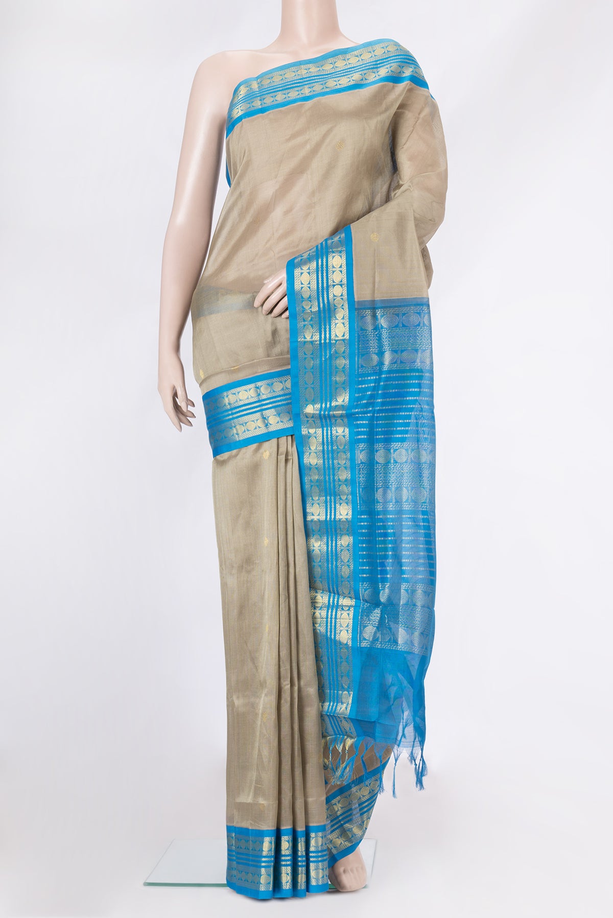 Dark Beige Silk Cotton Saree with Zari Butta on the body and Zari Border.  displayed on a mannequin