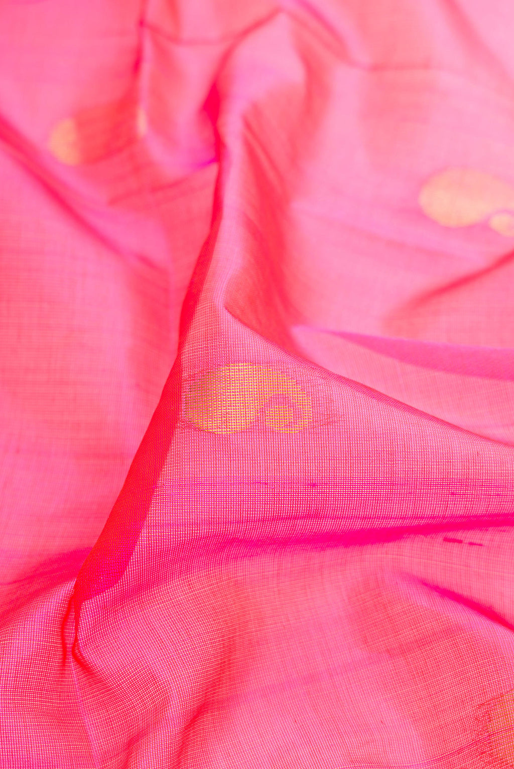 Close up of Pink Silk Cotton Saree with Zari Butta on the body and Zari Border.  displaying folds