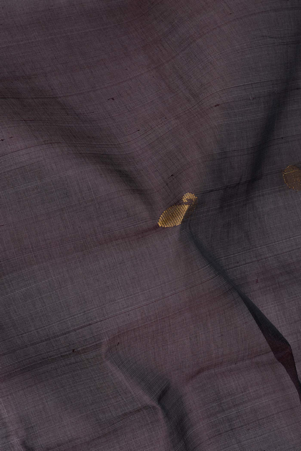 Close up of Coffee Brown Silk Cotton Saree with Zari Butta on the body and Zari Border.  displaying folds