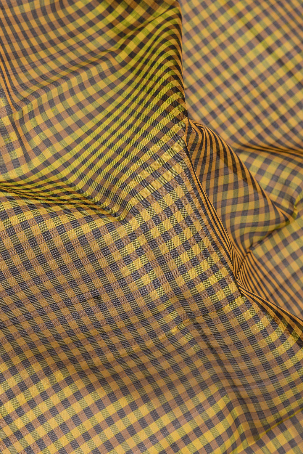 Close up of Multi Color Silk Cotton Saree with Checked design on the body and Zari Border.  displaying folds