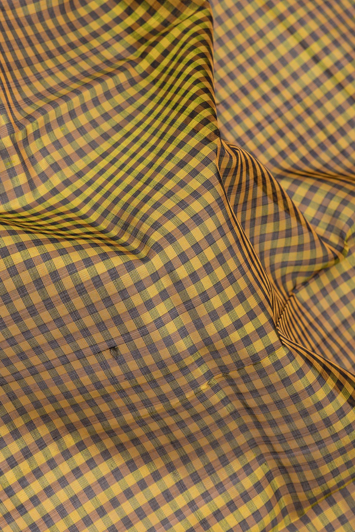 Close up of Multi Color Silk Cotton Saree with Checked design on the body and Zari Border.  displaying folds