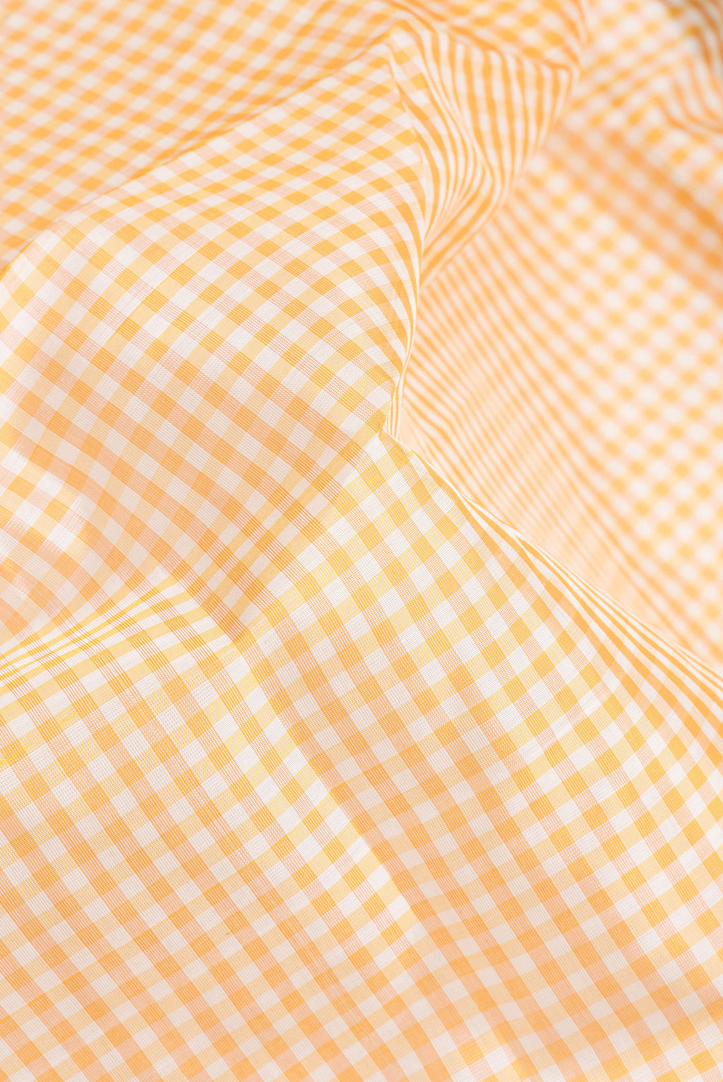 Close up of Yellow Silk Cotton Nine Yards Saree with Checked design on the body and Zari Border.  displaying folds