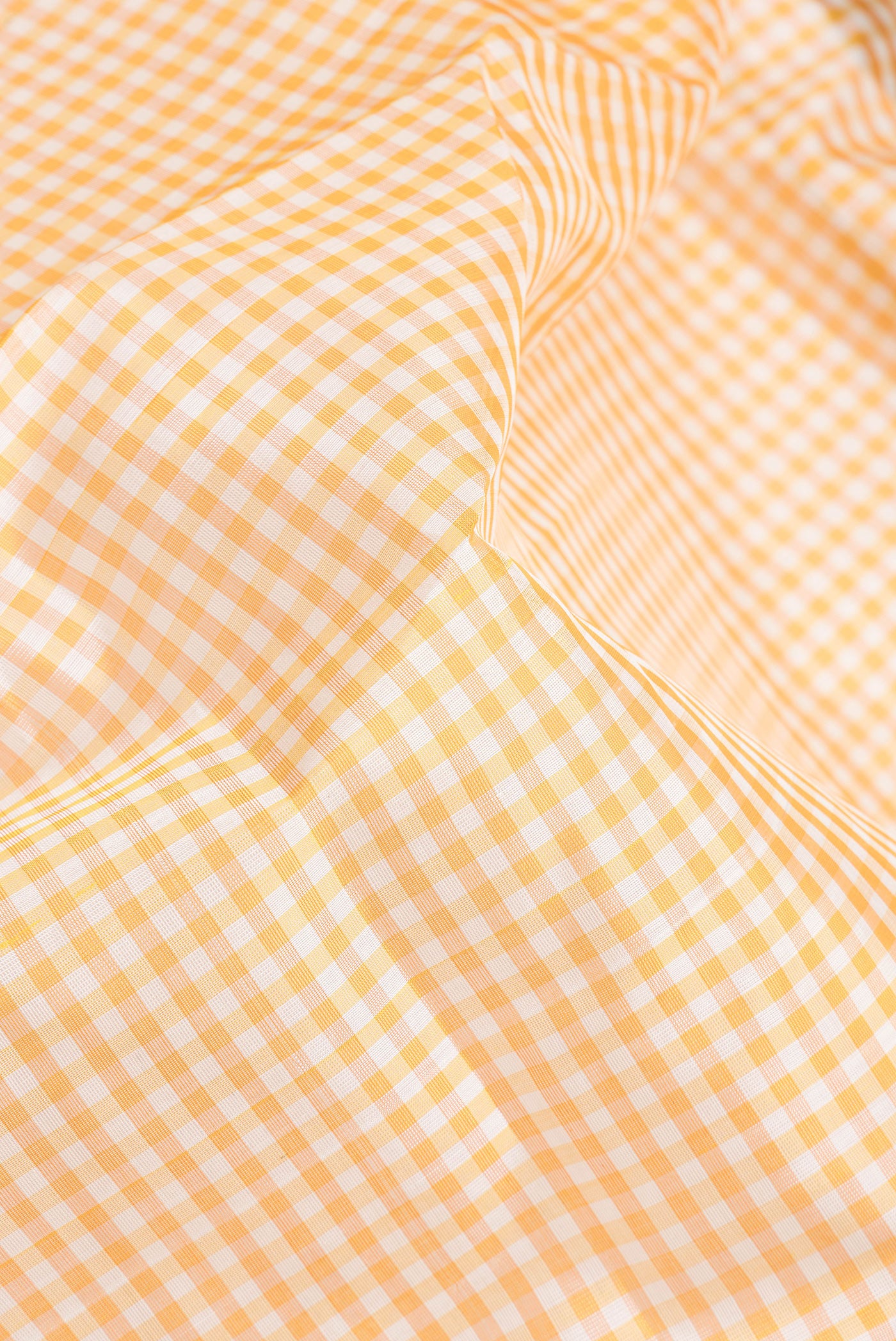 Close up of Yellow Silk Cotton Nine Yards Saree with Checked design on the body and Zari Border.  displaying folds