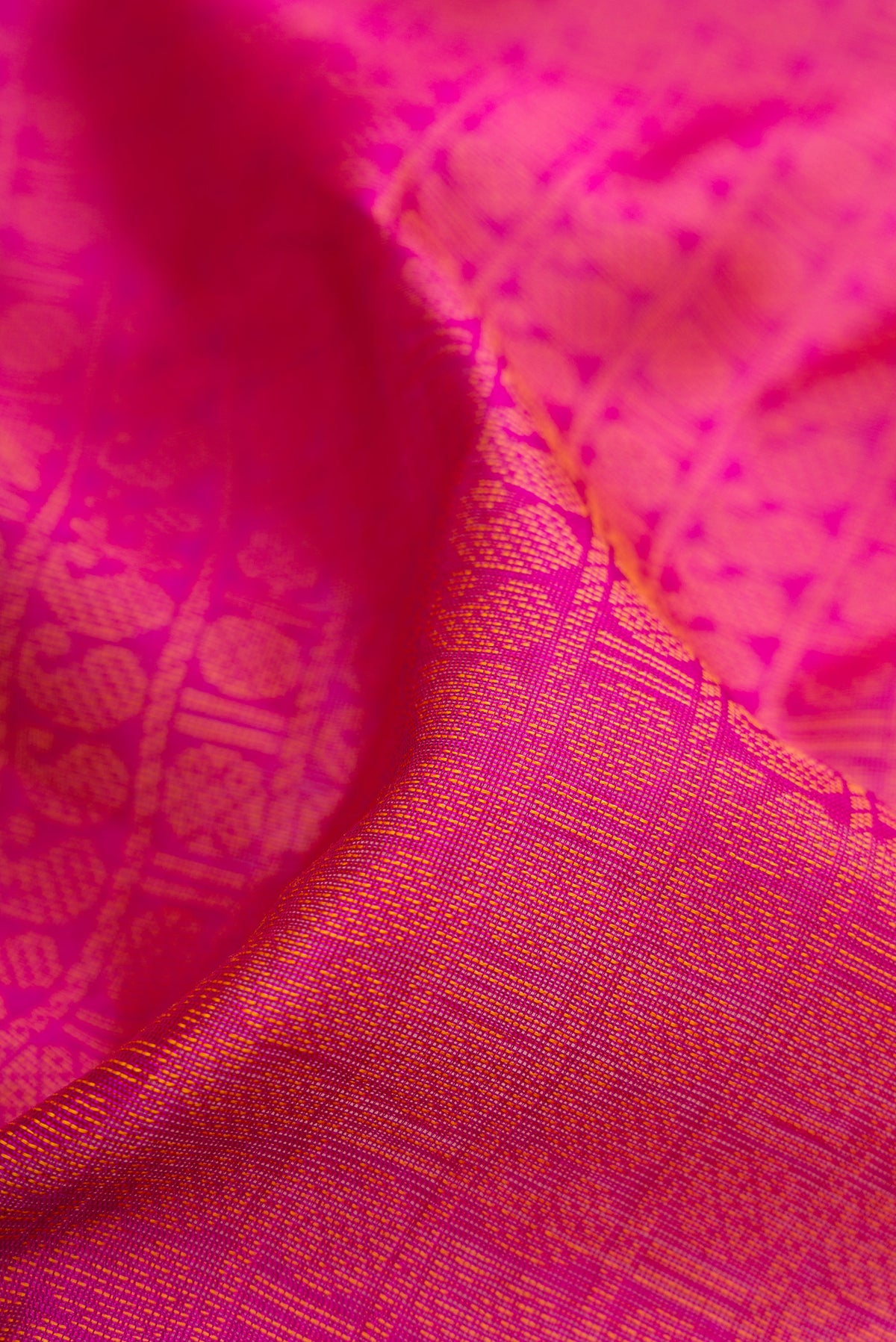 Close up of Magenta Silk Cotton Saree with Jacquard design on the body and Fancy Border.  displaying folds