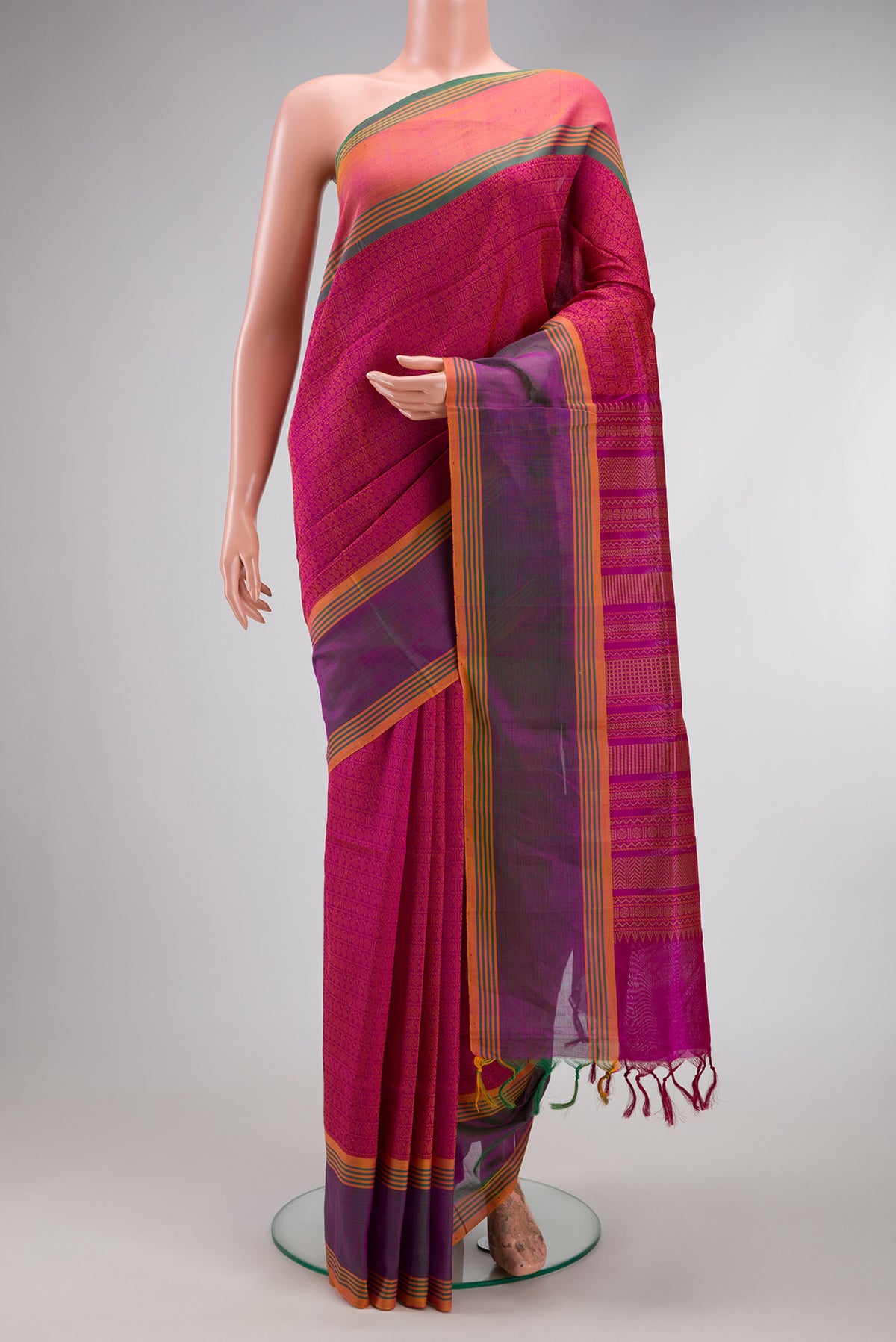 Magenta Silk Cotton Saree with Jacquard design on the body and Fancy Border.  displayed on a mannequin