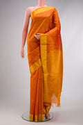 Orange Dual Tone Silk Cotton Saree with Checked design on the body and Zari Border.  displayed on a mannequin