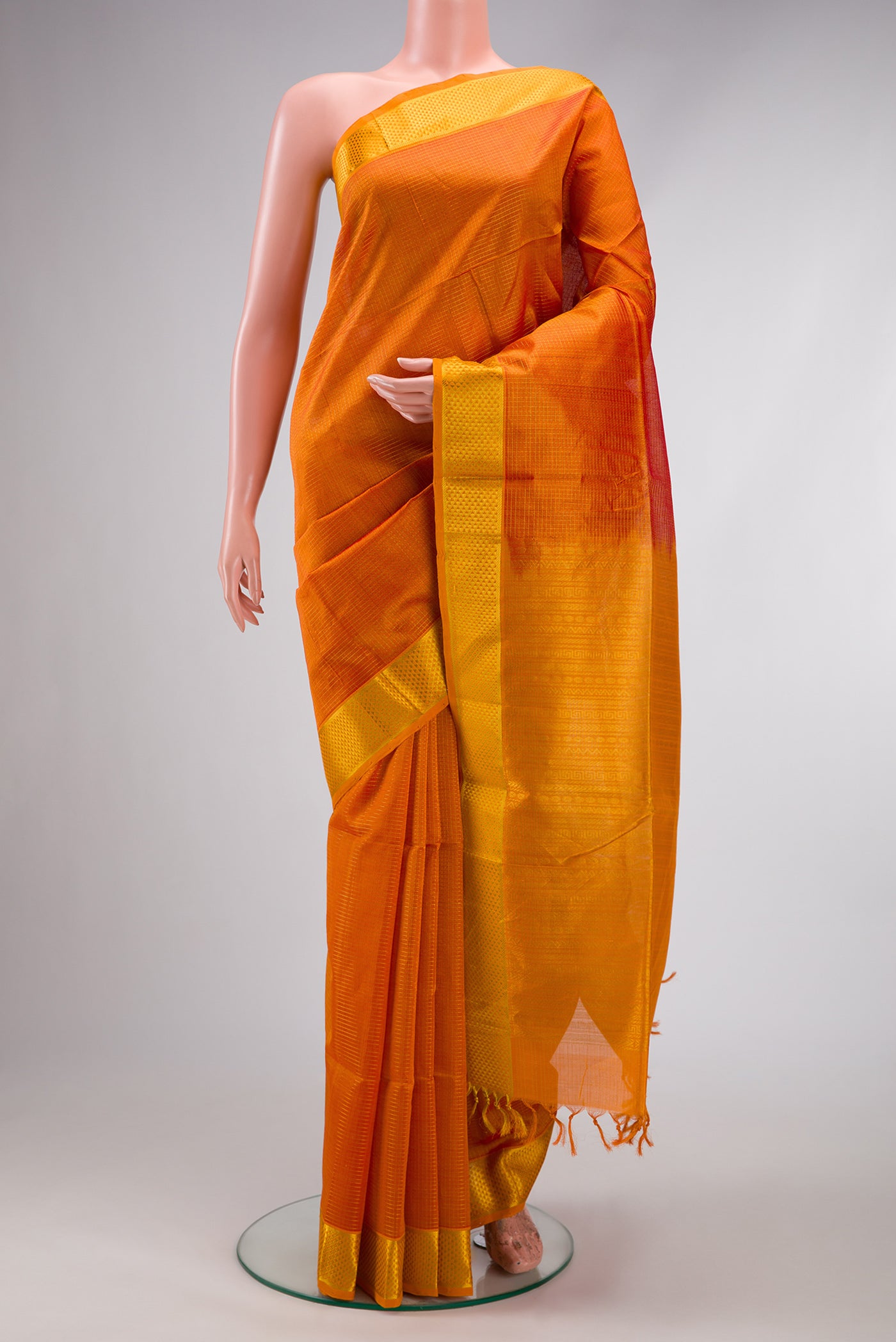 Orange Dual Tone Silk Cotton Saree with Checked design on the body and Zari Border.  displayed on a mannequin
