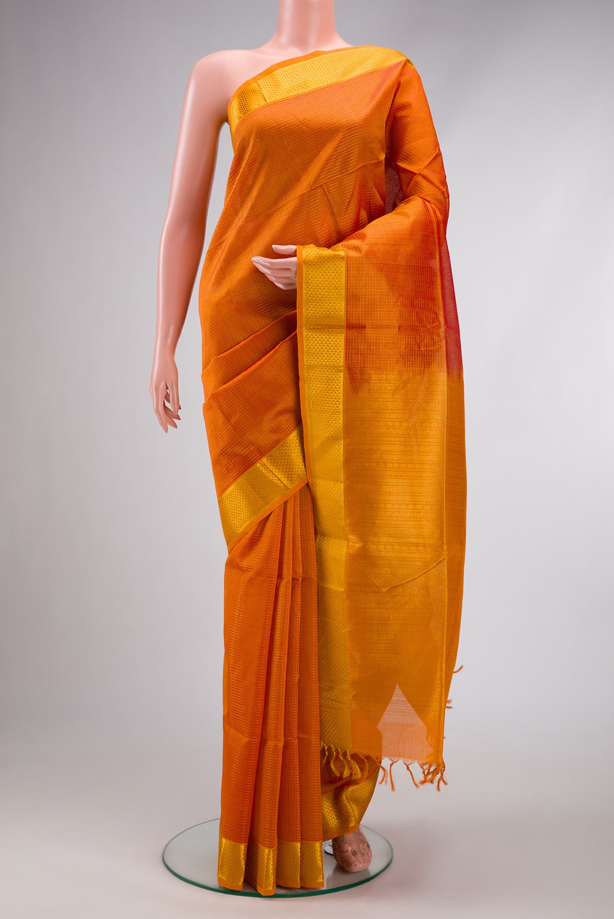 Orange Dual Tone Silk Cotton Saree with Checked design on the body and Zari Border.  displayed on a mannequin