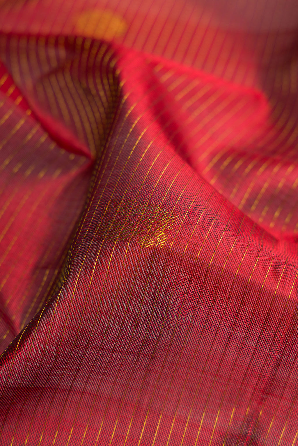 Close up of Maroon Silk Cotton Saree with Stripes on the body and Zari Border.  displaying folds