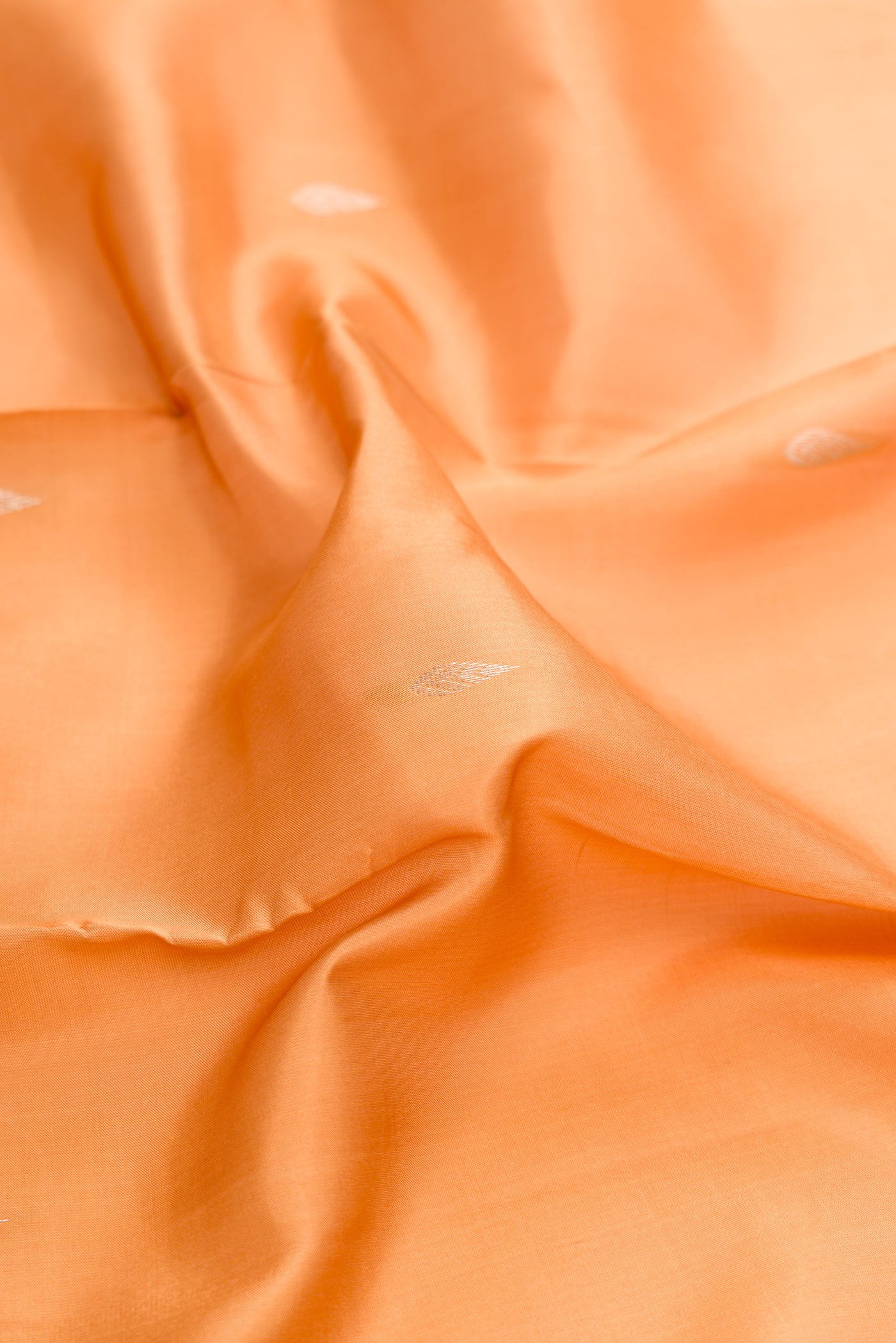 Close up of Sandal Dual Tone Kanchipuram Silk Saree with Zari Butta on the body and Zari Border.  displaying folds