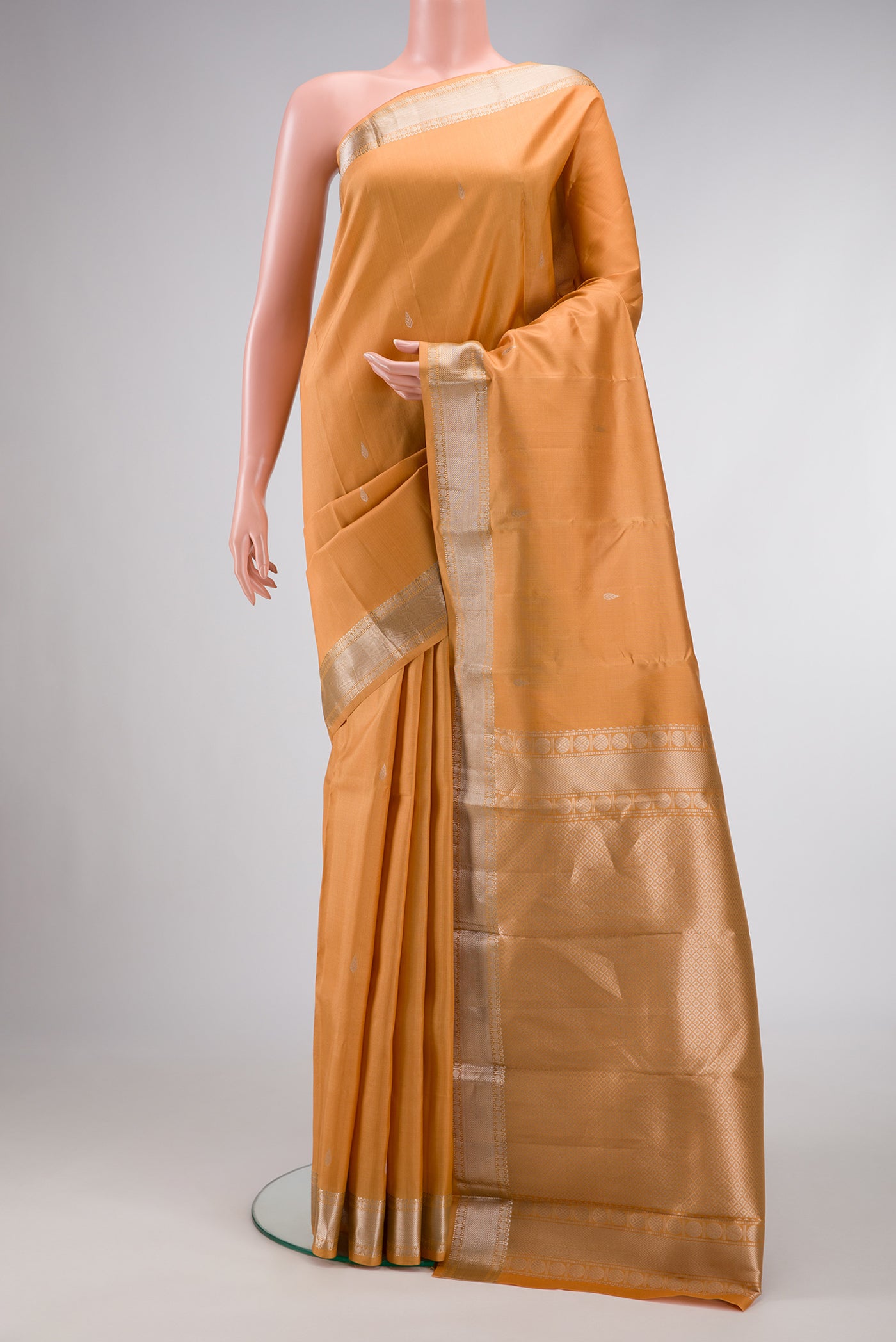 Sandal Dual Tone Kanchipuram Silk Saree with Zari Butta on the body and Zari Border.  displayed on a mannequin