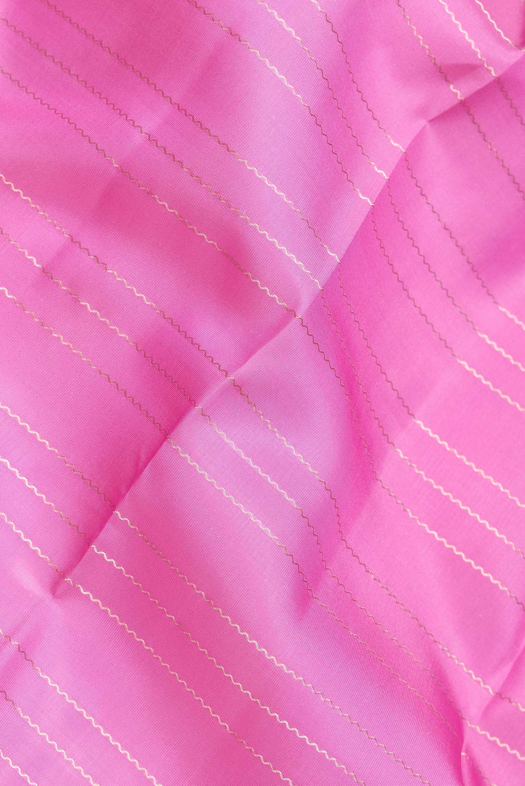 Close up of Pink Dual Tone Kanchipuram Silk Saree with Stripes on the body and Zari Border.  displaying folds