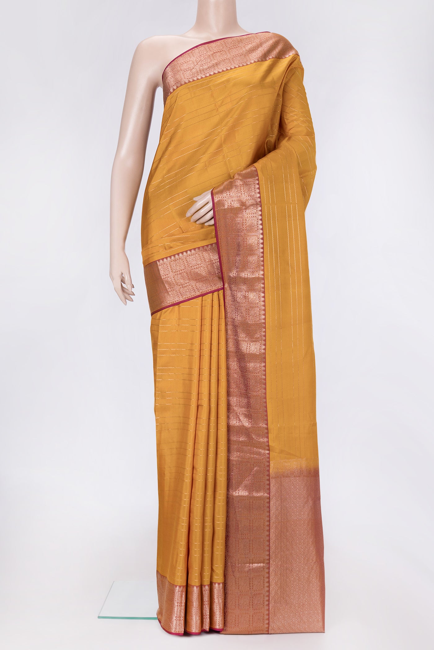 Mustard Dual Tone Kanchipuram Silk Saree with Stripes on the body and Zari Border.  displayed on a mannequin