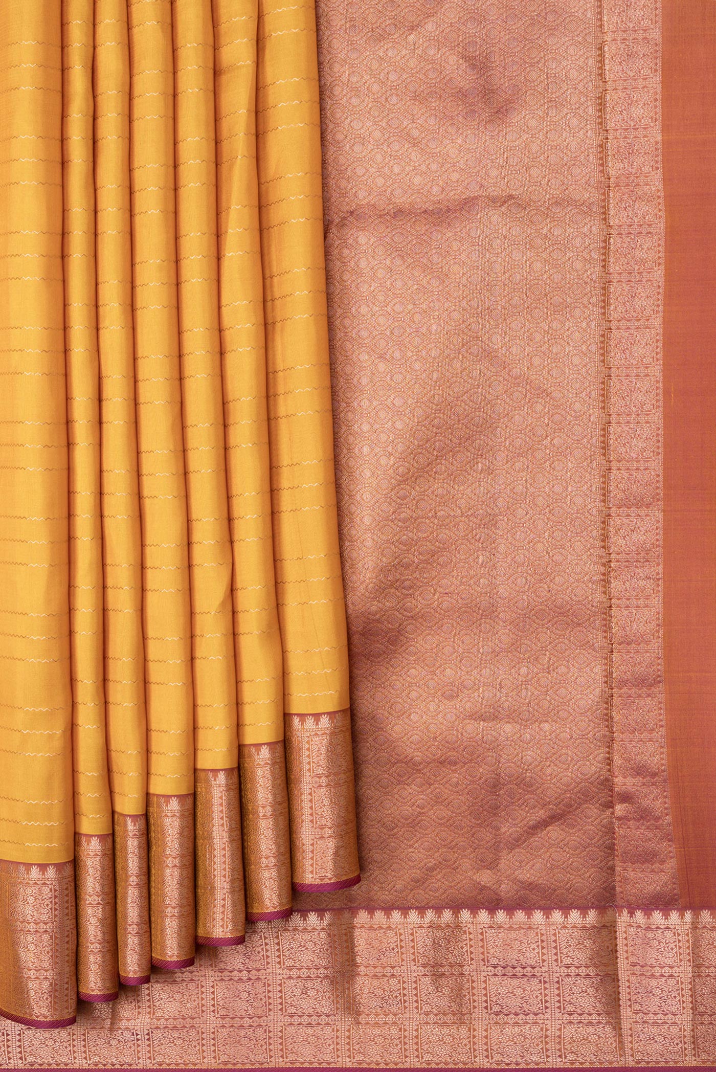 Pleats and pallu of Mustard Dual Tone Kanchipuram Silk Saree with Stripes on the body and Zari Border. 