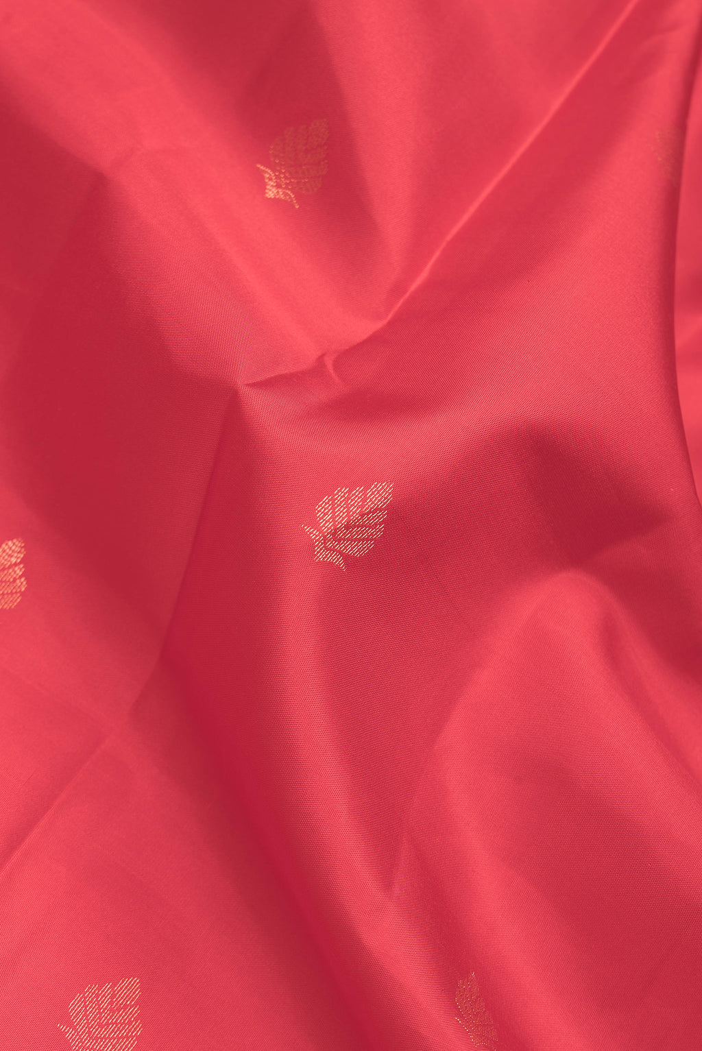 Close up of Red Dual Tone Kanchipuram Silk Saree with Zari Butta on the body and Zari Border.  displaying folds