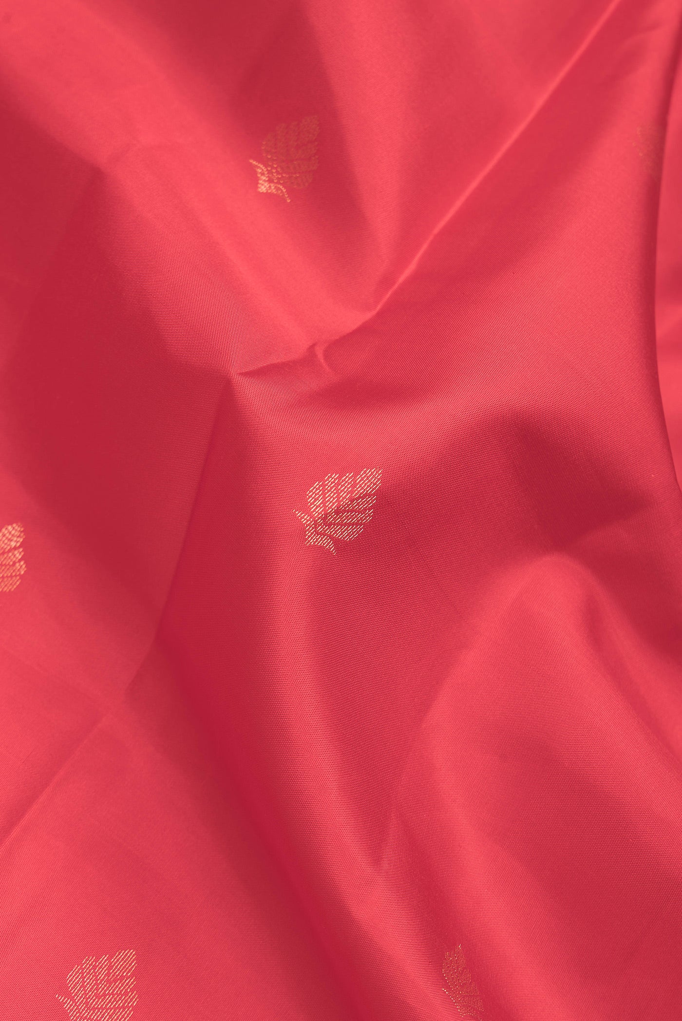 Close up of Red Dual Tone Kanchipuram Silk Saree with Zari Butta on the body and Zari Border.  displaying folds