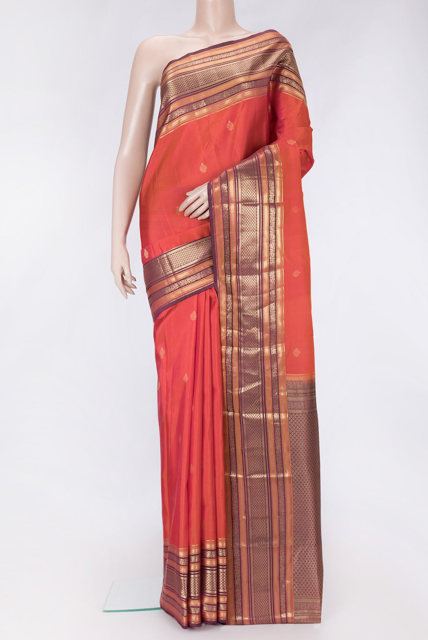 Orange Dual Tone Kanchipuram Silk Saree with Zari Butta on the body and Zari Border.  displayed on a mannequin