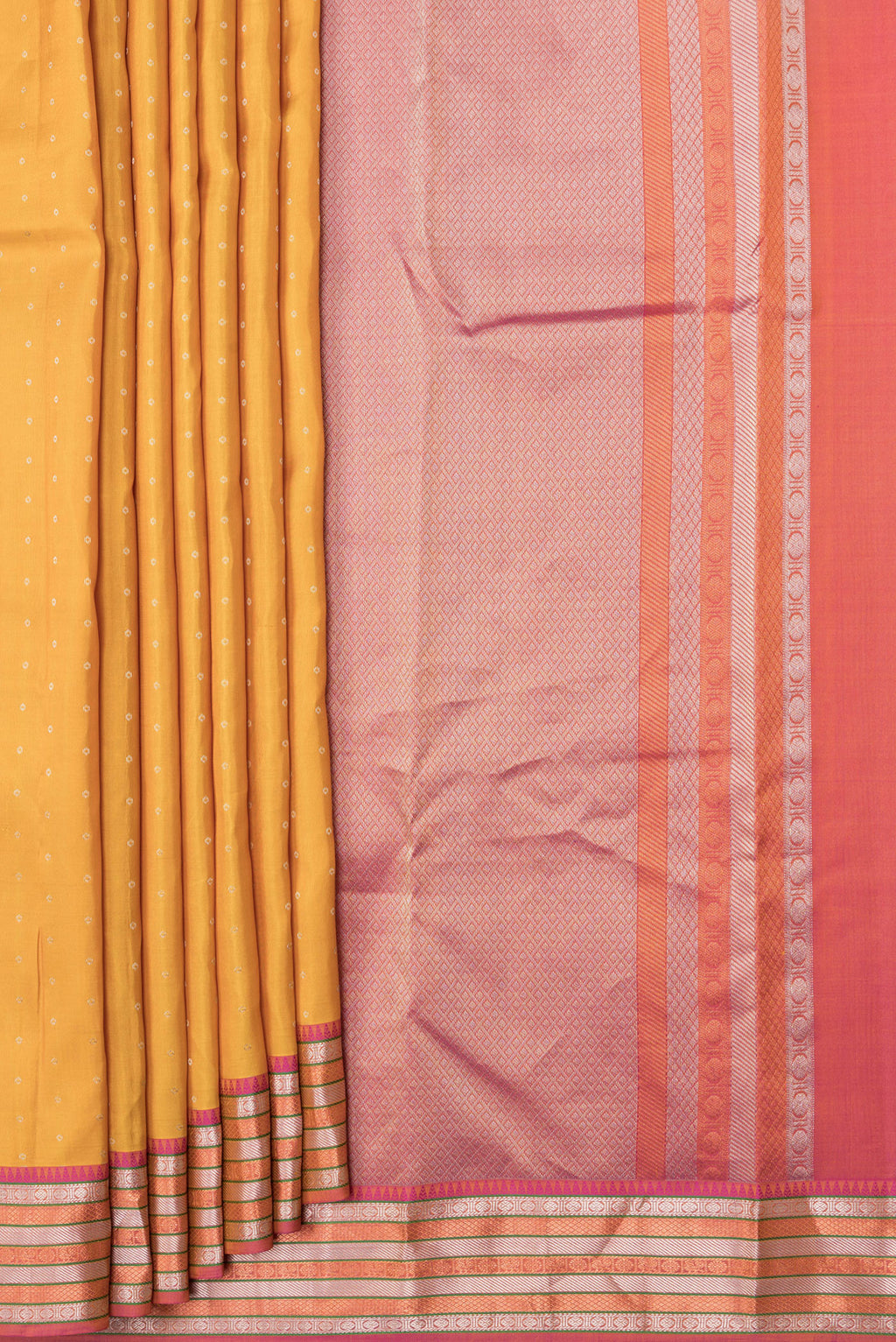 Pleats and pallu of Mustard Dual Tone Kanchipuram Silk Saree with Zari Butta on the body and Zari Border. 