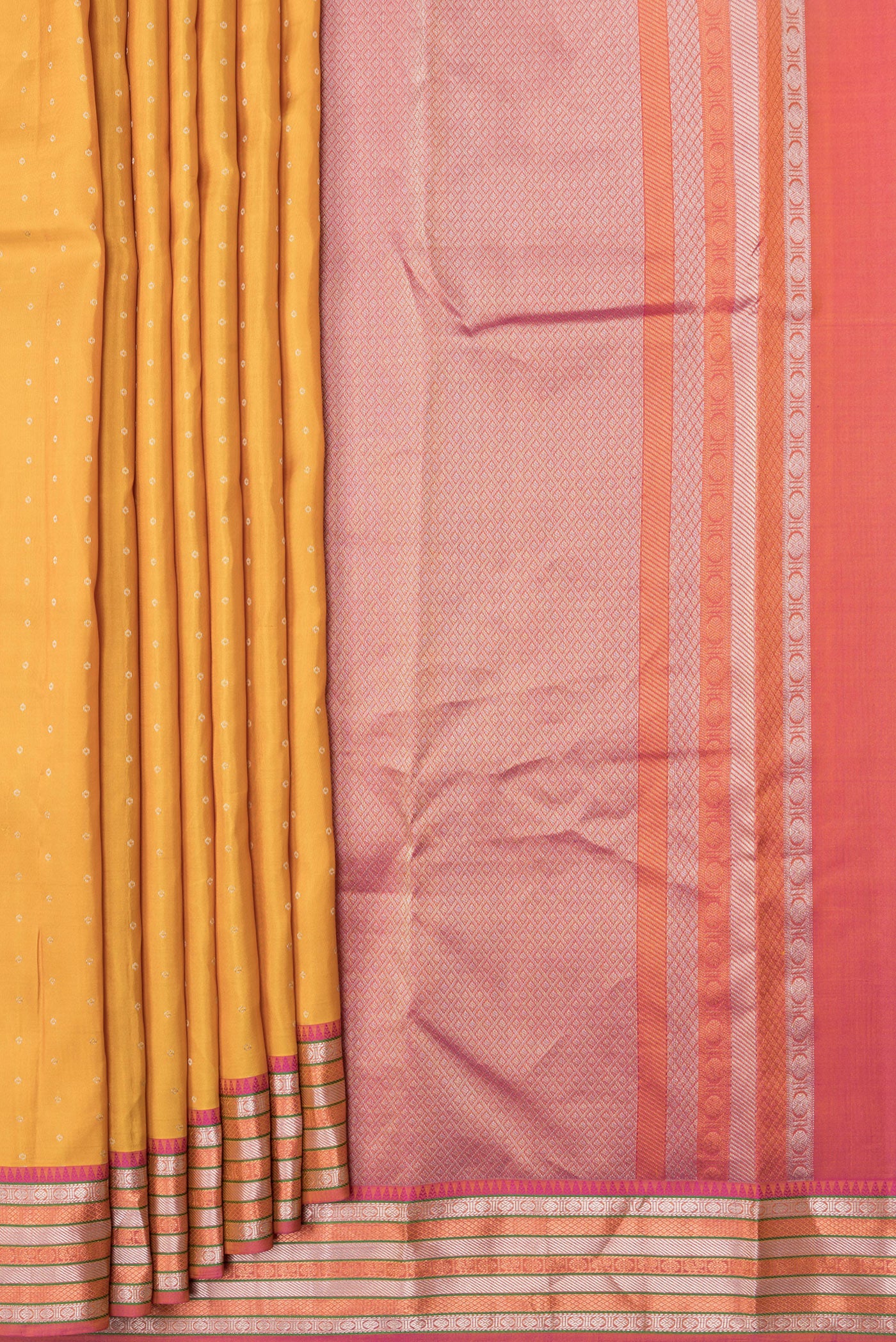 Pleats and pallu of Mustard Dual Tone Kanchipuram Silk Saree with Zari Butta on the body and Zari Border. 