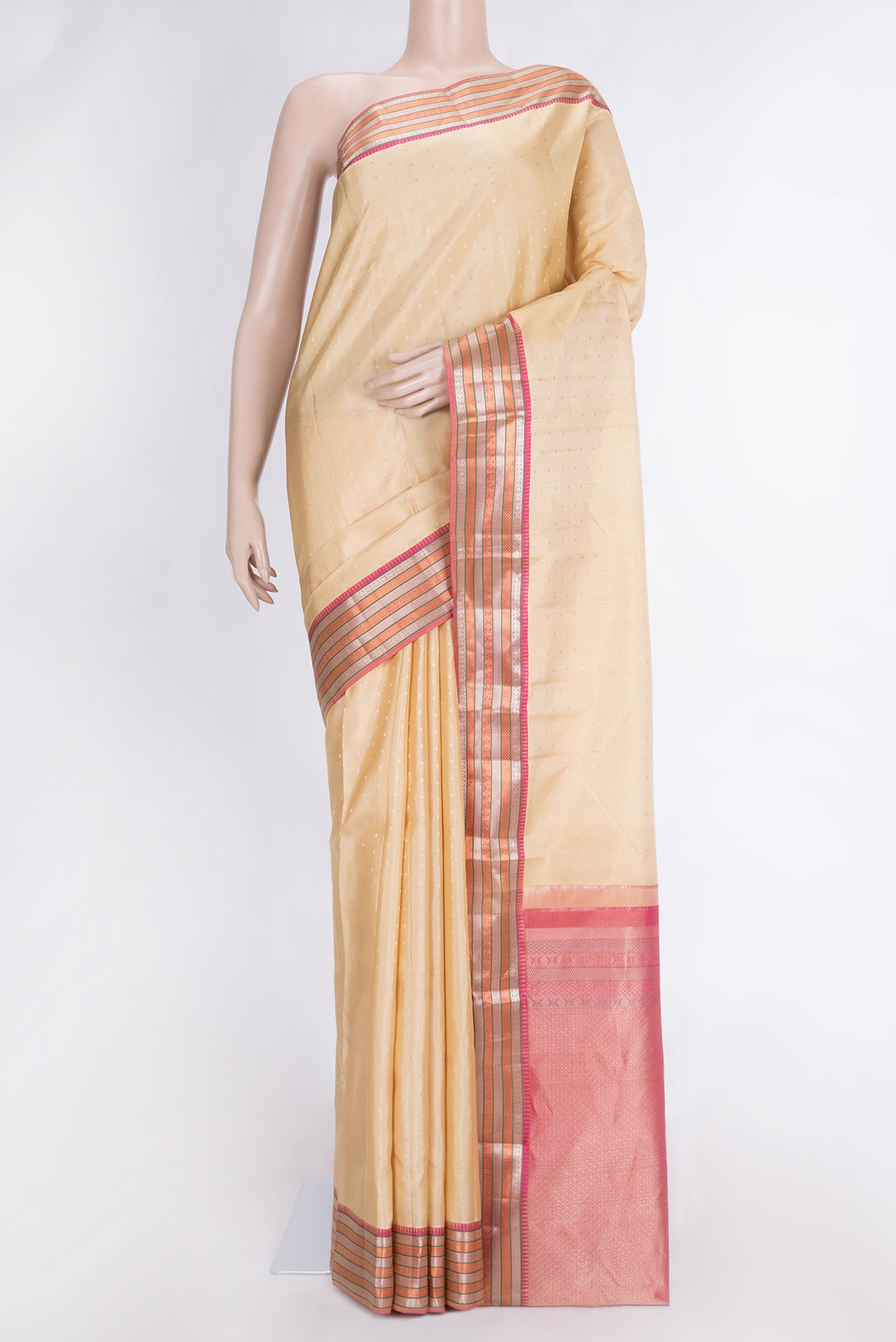 Beige Dual Tone Kanchipuram Silk Saree with Zari Butta on the body and Zari Border.  displayed on a mannequin