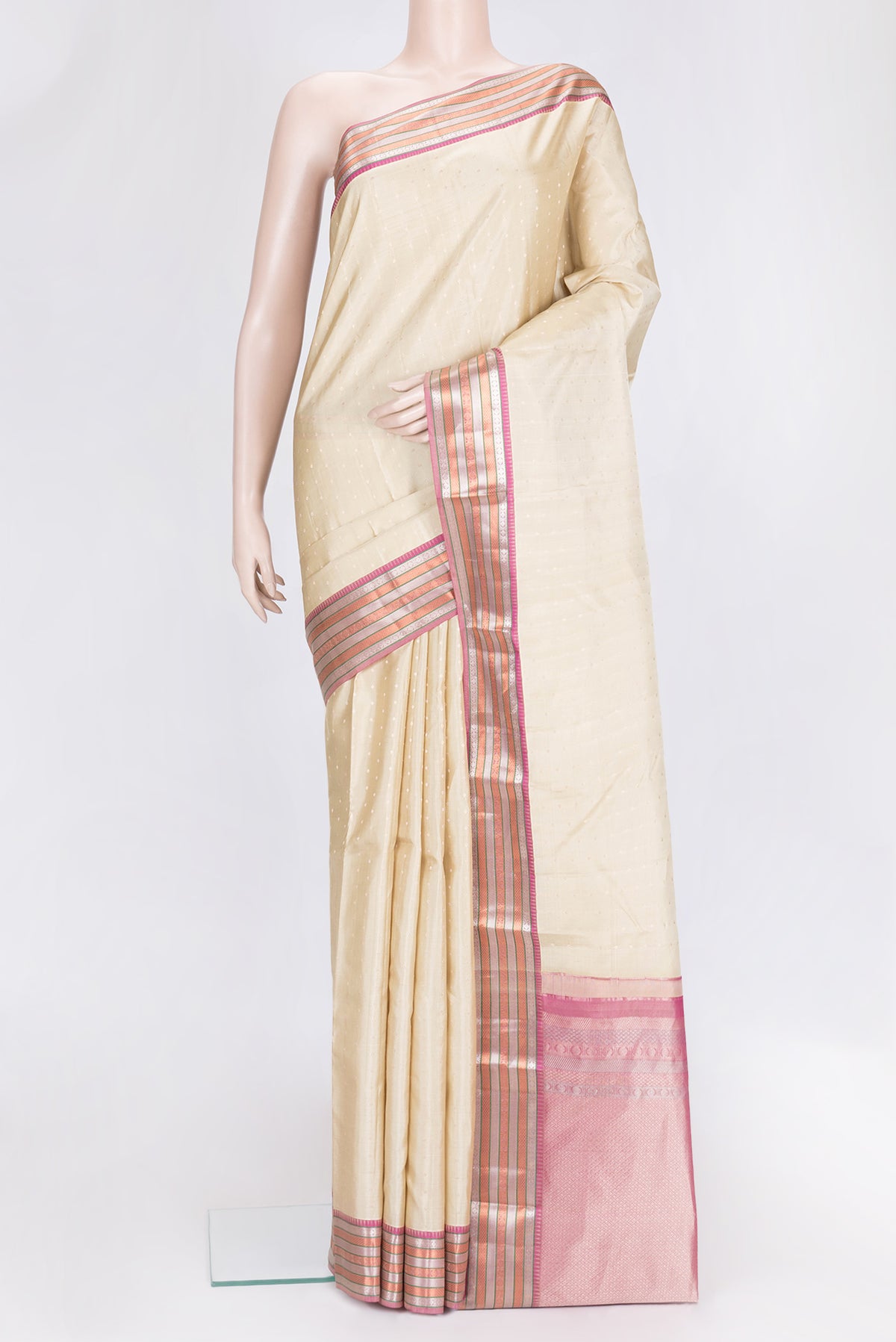 Beige Dual Tone Kanchipuram Silk Saree with Zari Butta on the body and Zari Border.  displayed on a mannequin