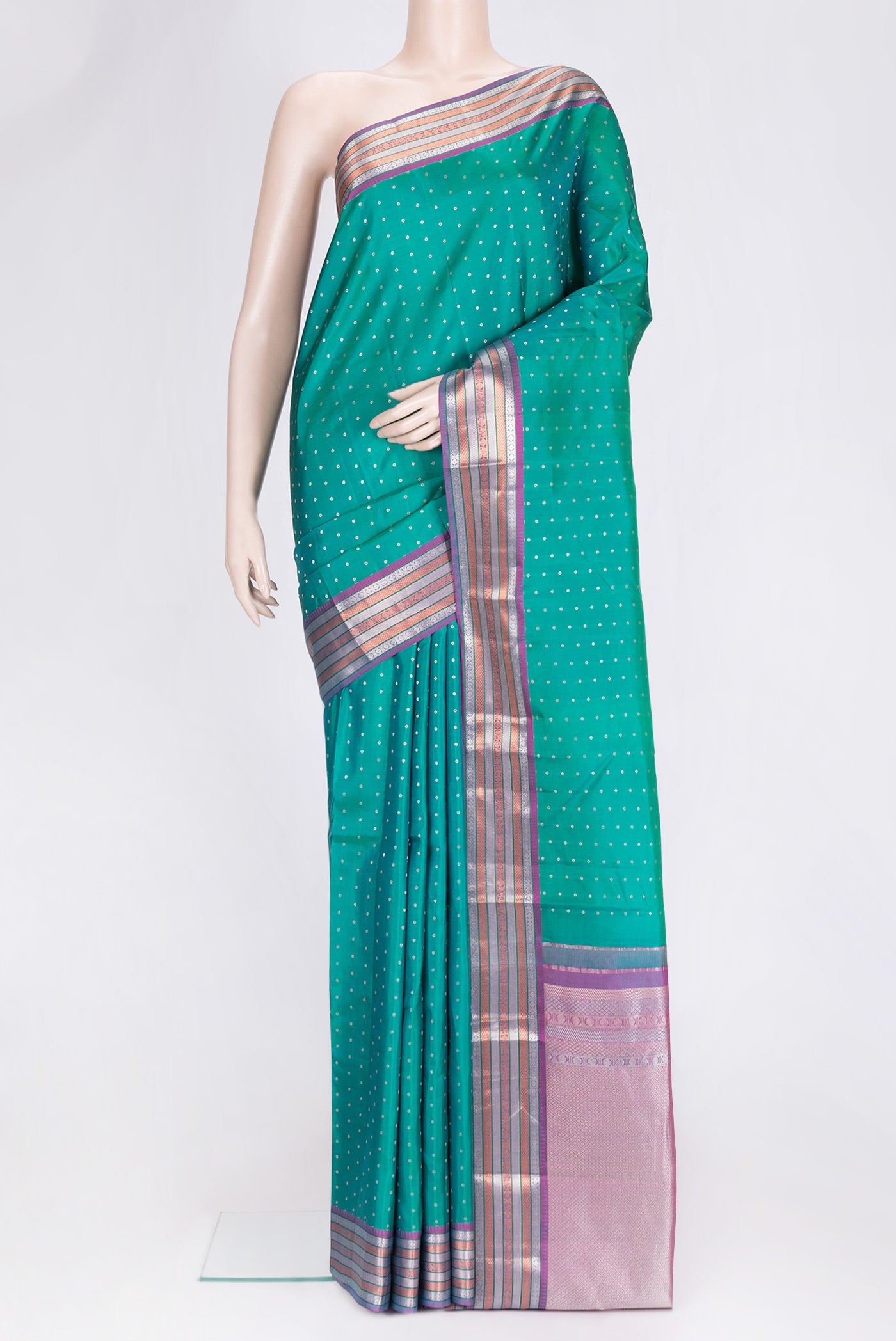 Green Dual Tone Kanchipuram Silk Saree with Zari Butta on the body and Zari Border.  displayed on a mannequin