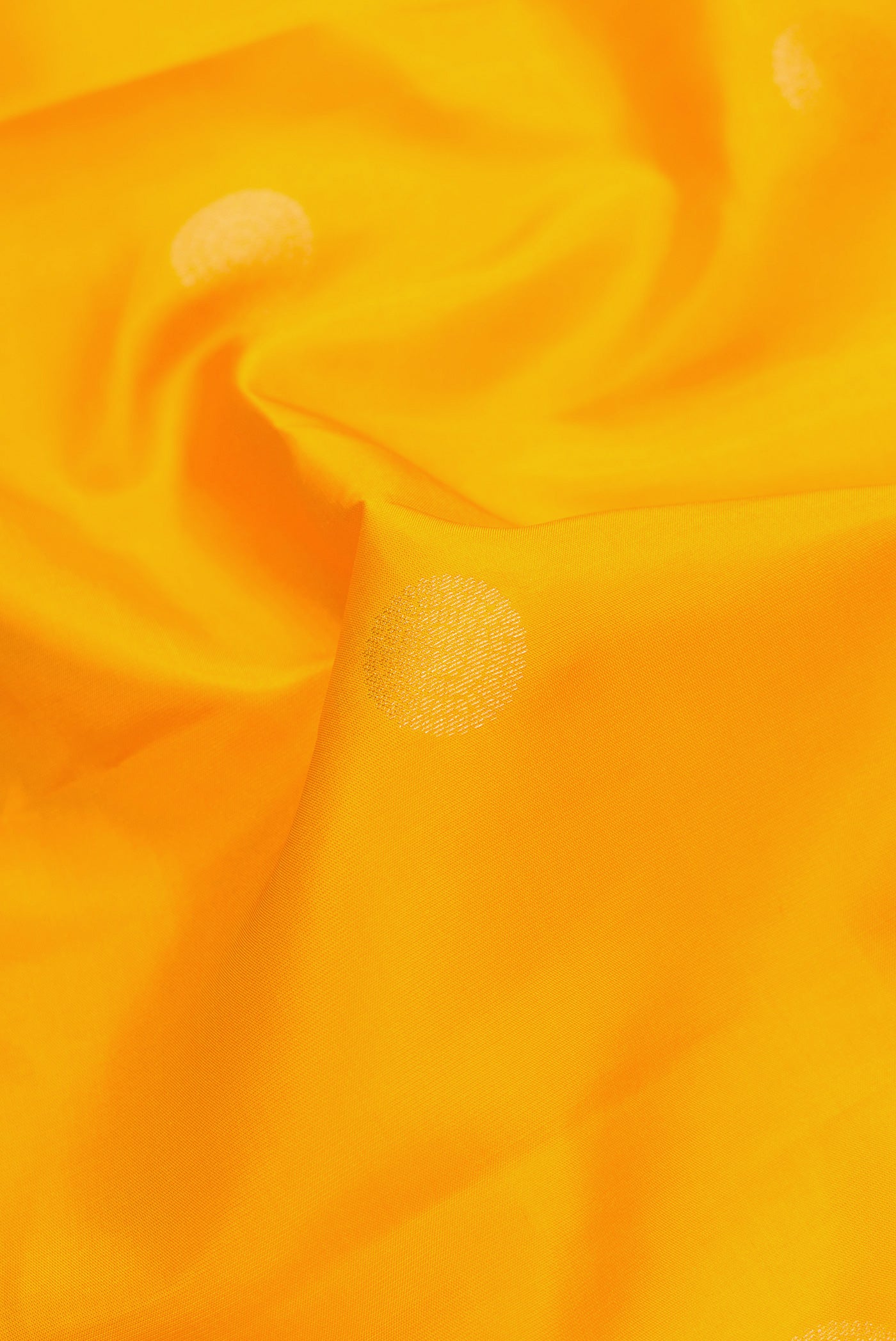 Close up of Mustard Dual Tone Kanchipuram Silk Saree with Zari Butta on the body and Zari Border.  displaying folds
