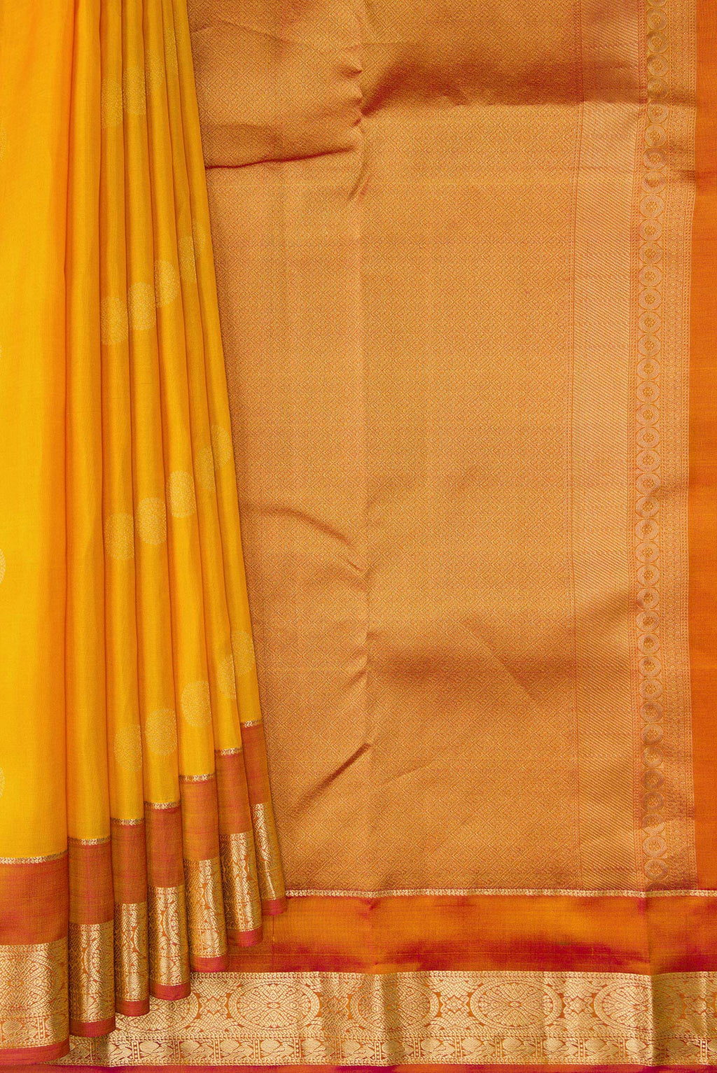Pleats and pallu of Mustard Dual Tone Kanchipuram Silk Saree with Zari Butta on the body and Zari Border. 