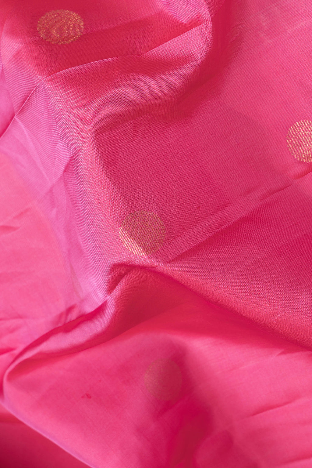 Close up of Pink Dual Tone Kanchipuram Silk Saree with Zari Butta on the body and Zari Border.  displaying folds