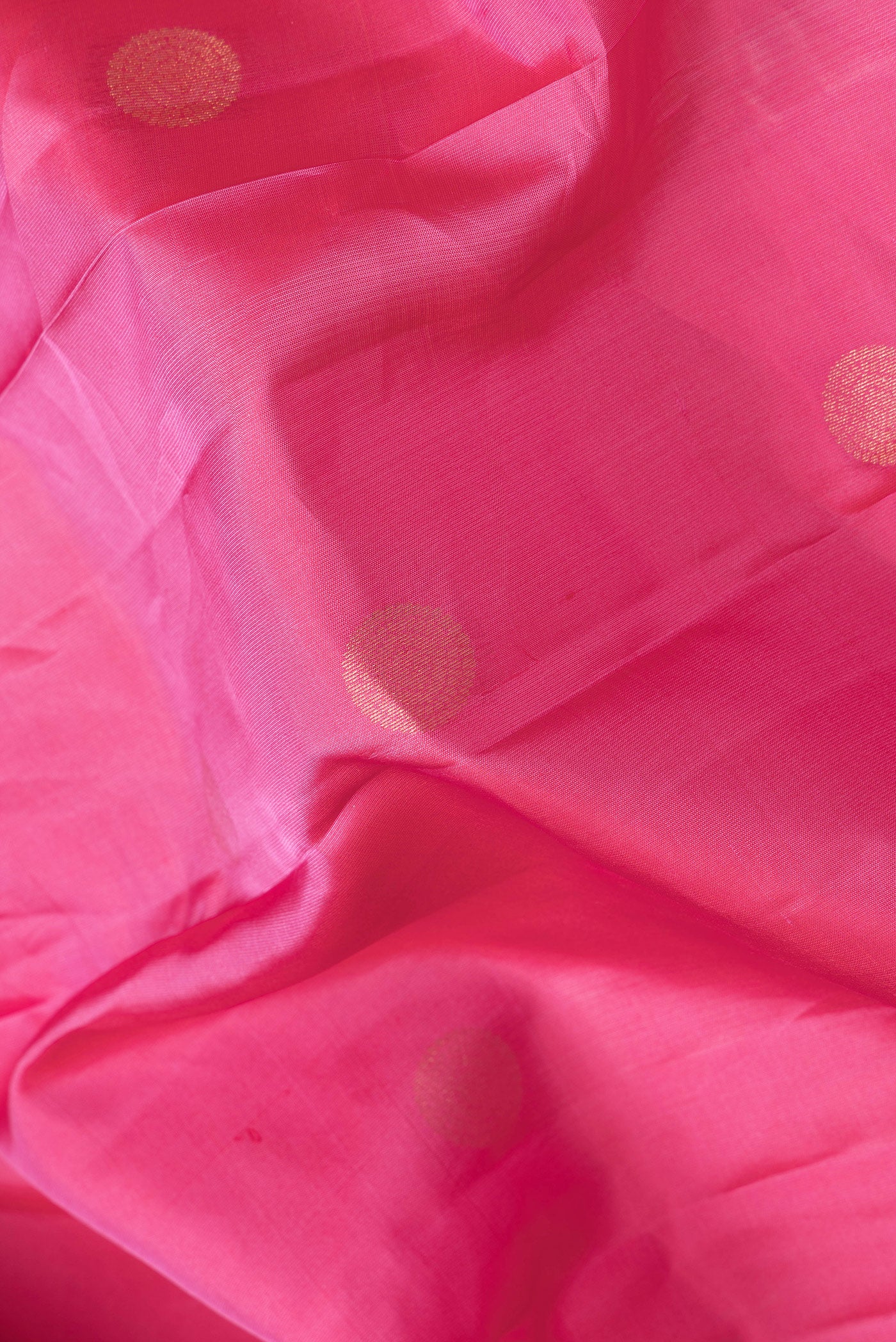 Close up of Pink Dual Tone Kanchipuram Silk Saree with Zari Butta on the body and Zari Border.  displaying folds