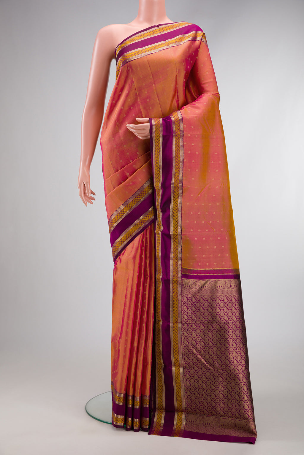 Coral Dual Tone Kanchipuram Silk Saree with Zari Butta on the body and Zari And Thread Border.  displayed on a mannequin