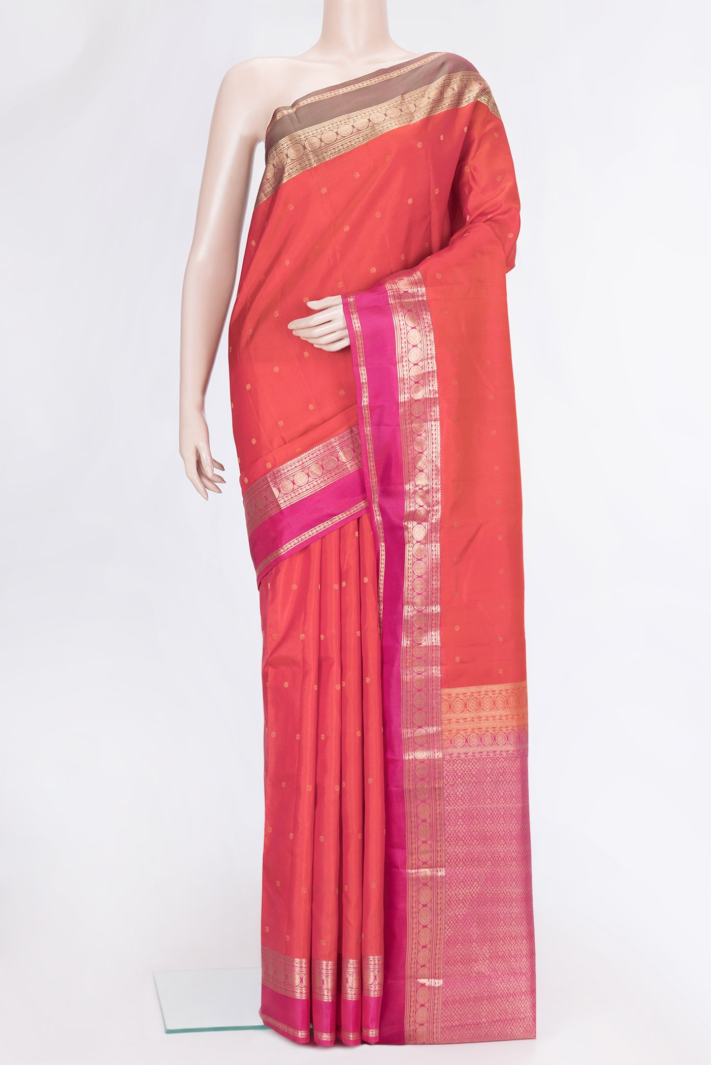Orange Dual Tone Kanchipuram Silk Saree with Zari Butta on the body and Zari Border.  displayed on a mannequin