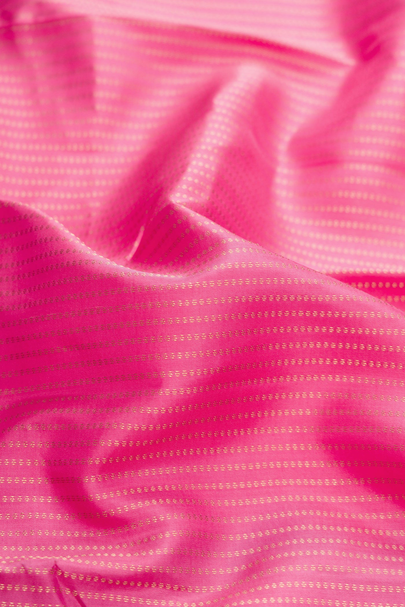 Close up of Pink Dual Tone Kanchipuram Silk Saree with Stripes on the body and Zari Border.  displaying folds
