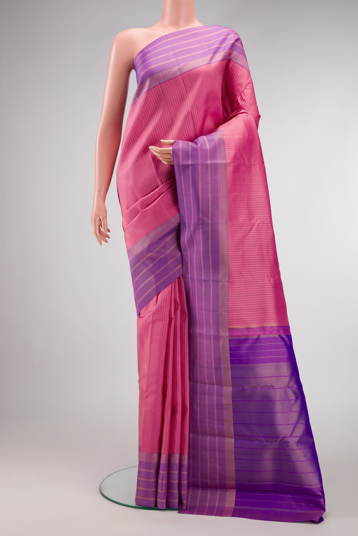 Pink Dual Tone Kanchipuram Silk Saree with Stripes on the body and Zari Border.  displayed on a mannequin