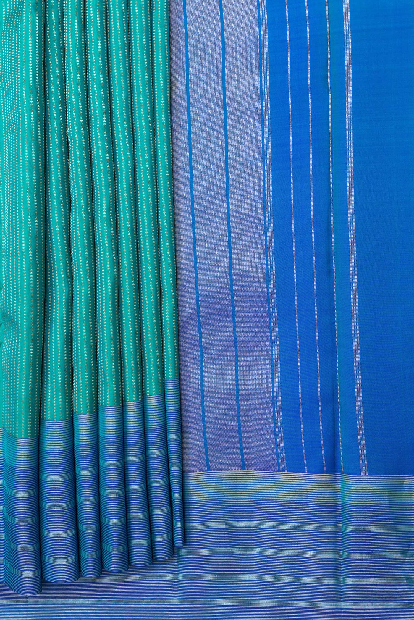 Pleats and pallu of Green Dual Tone Kanchipuram Silk Saree with Stripes on the body and Zari Border. 