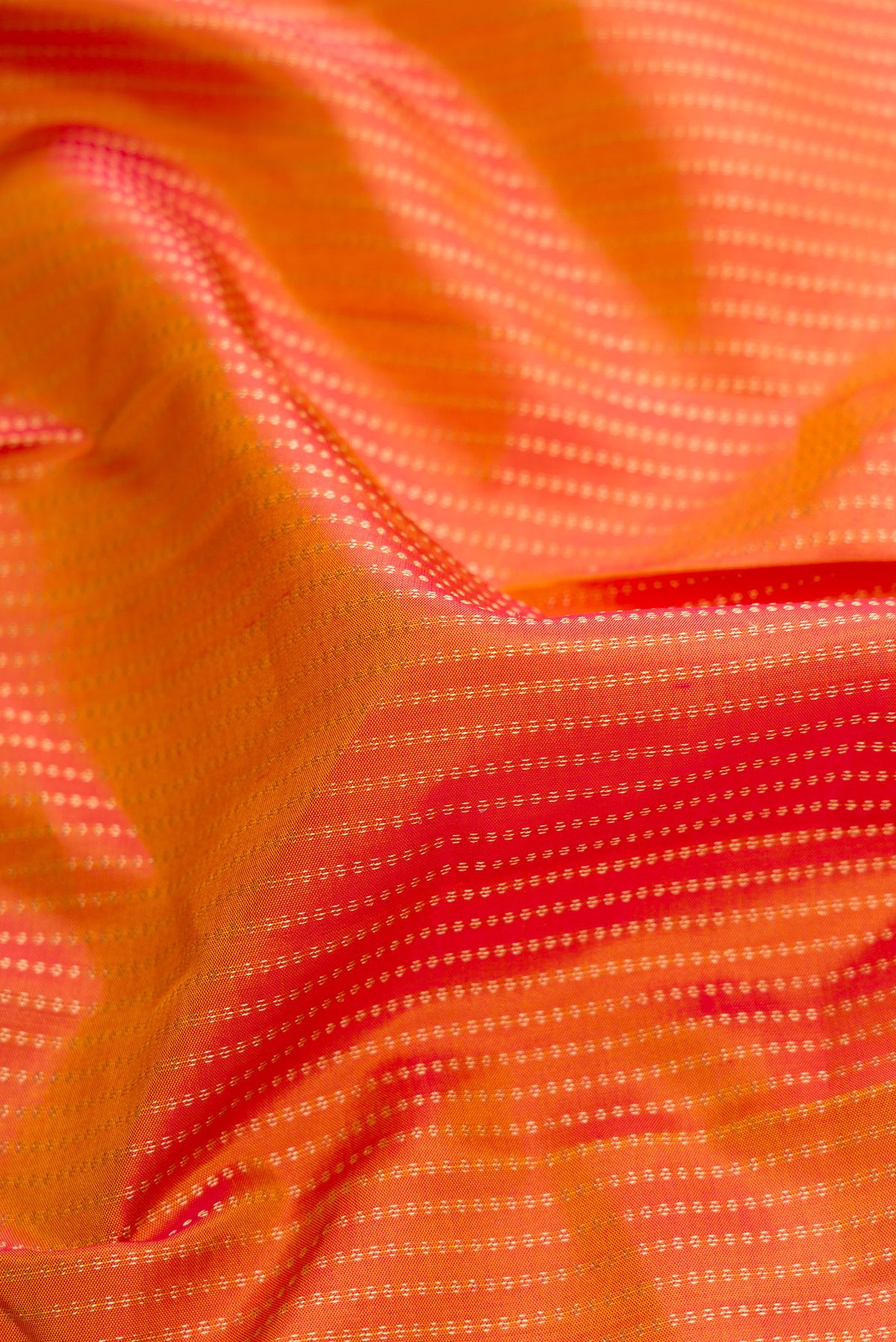 Close up of Mustard Dual Tone Kanchipuram Silk Saree with Stripes on the body and Zari Border.  displaying folds