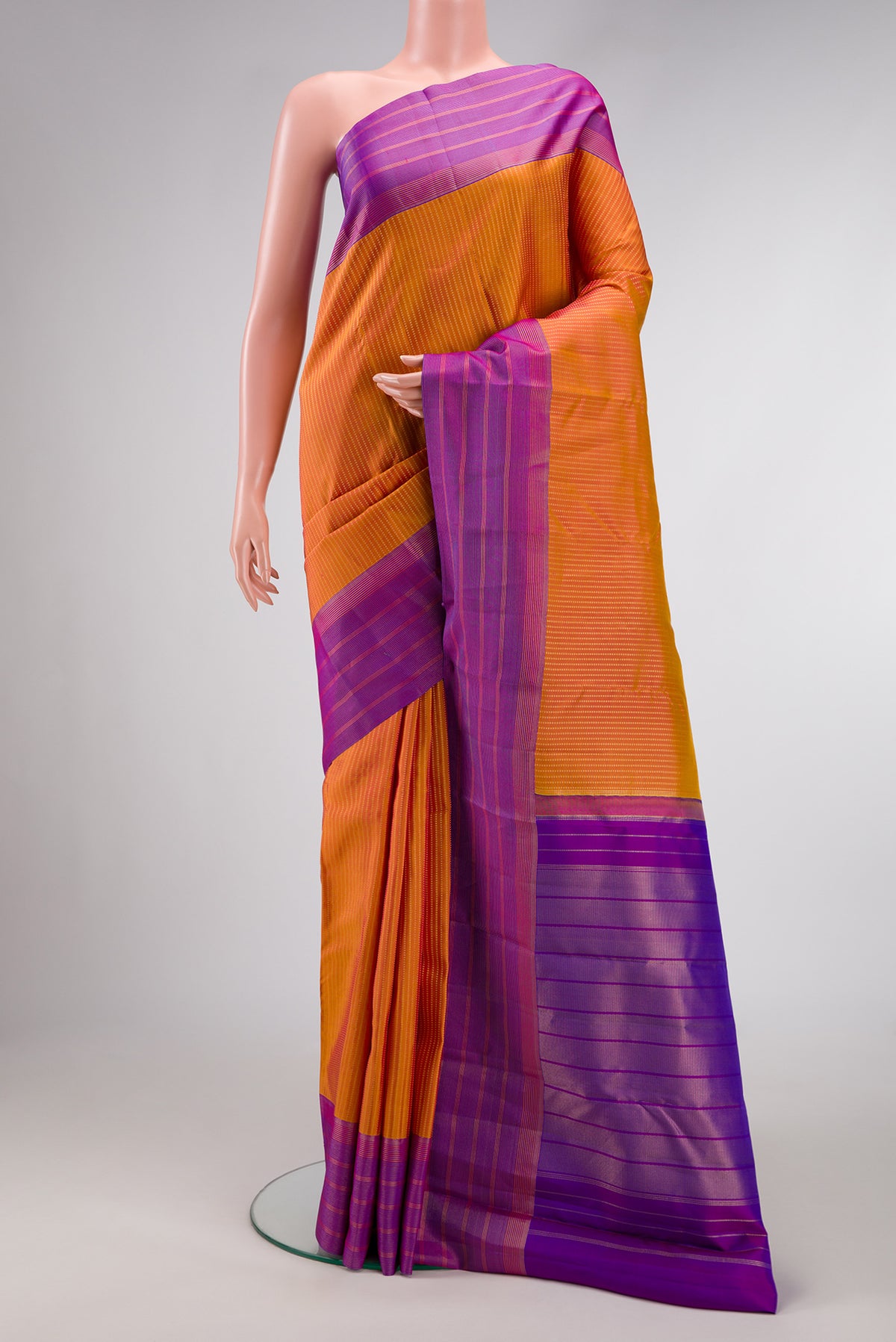 Mustard Dual Tone Kanchipuram Silk Saree with Stripes on the body and Zari Border.  displayed on a mannequin